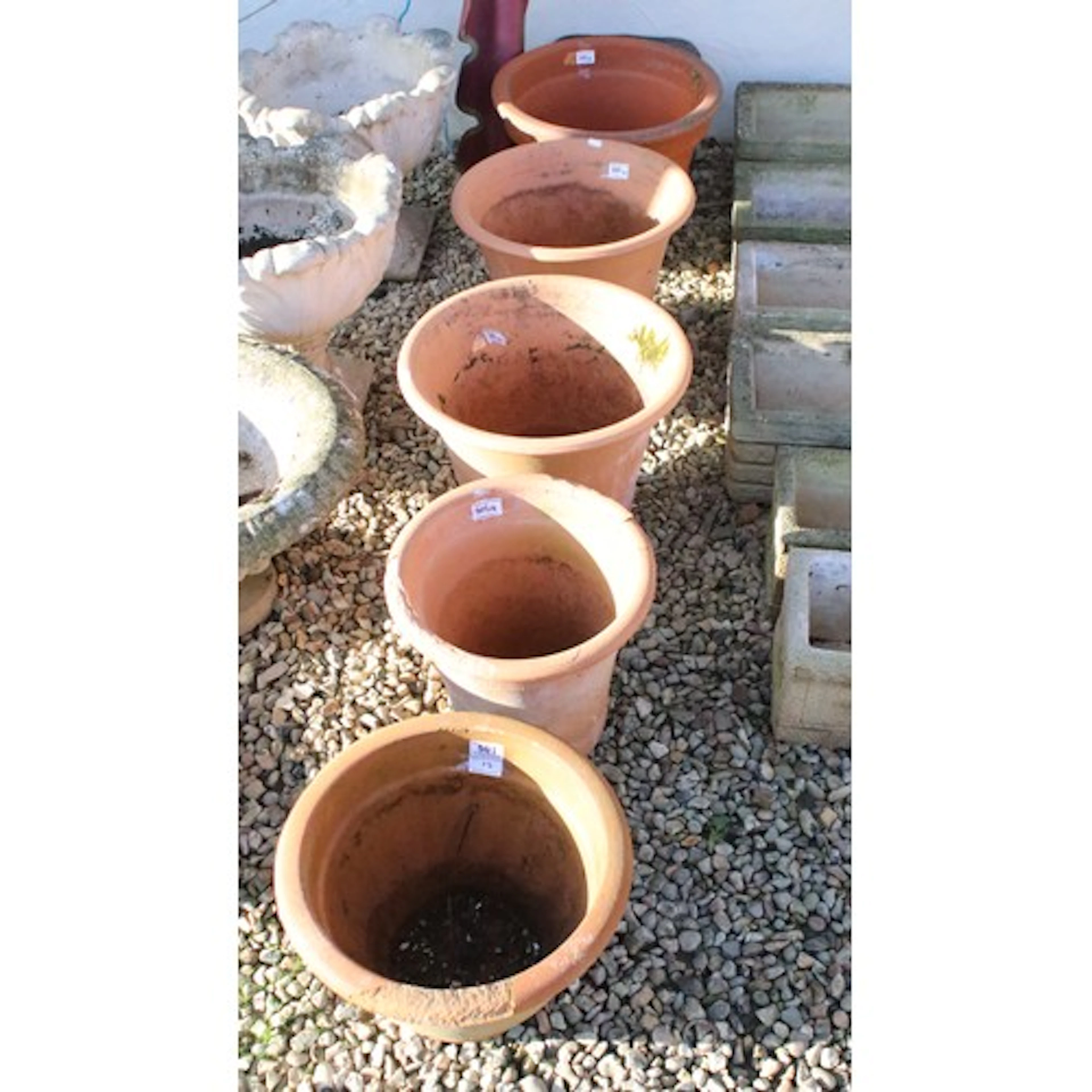 Five terracotta garden pots having flared rims to include tw...