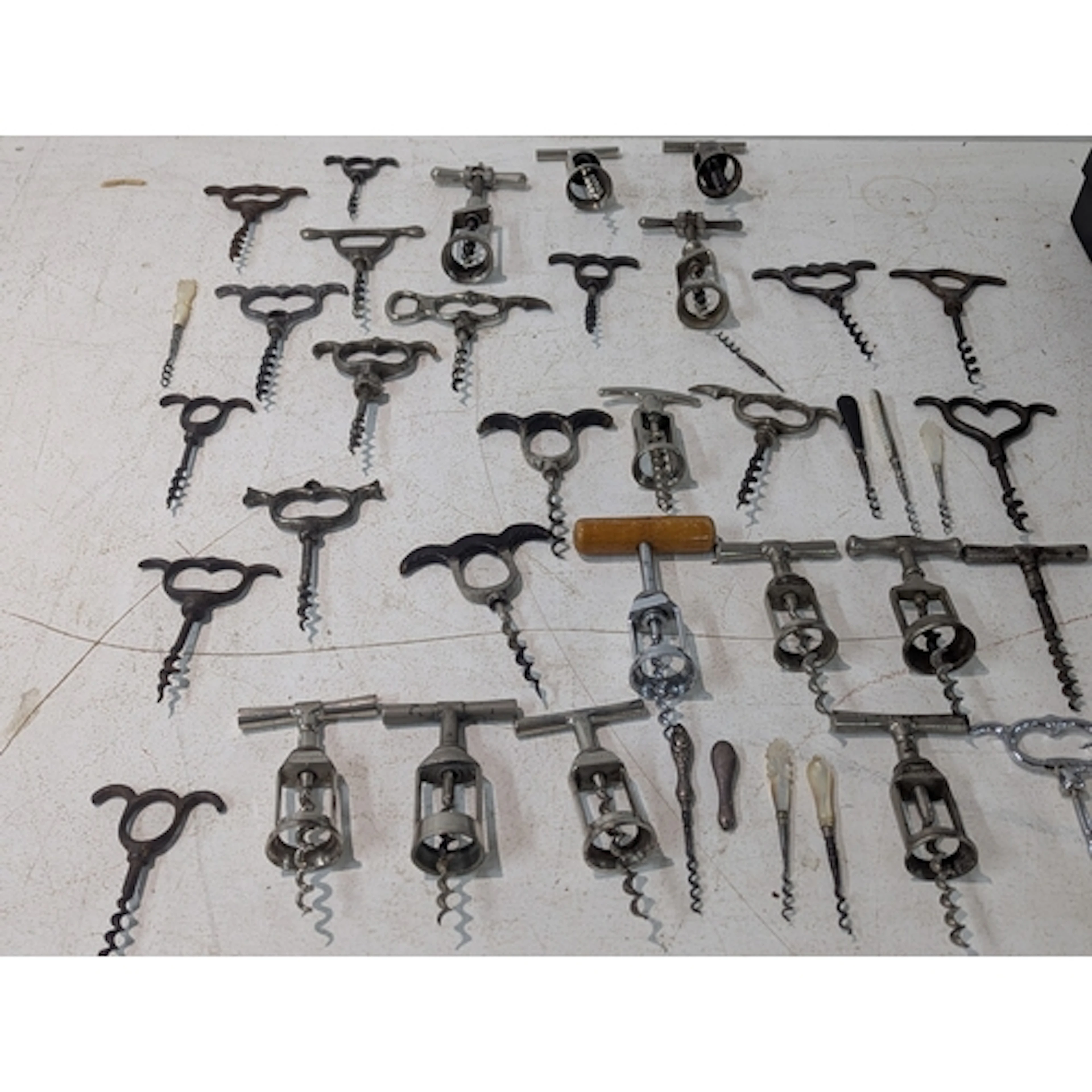 A collection of corkscrews to include small silver handled a...