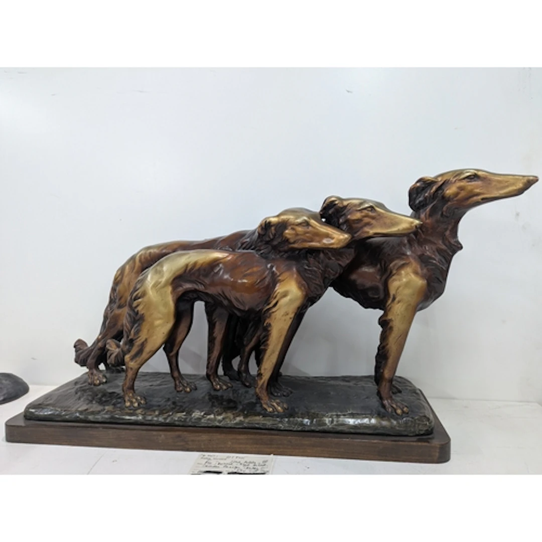 A large Art Deco Sculpture of three Borzoi in motion, in pla...