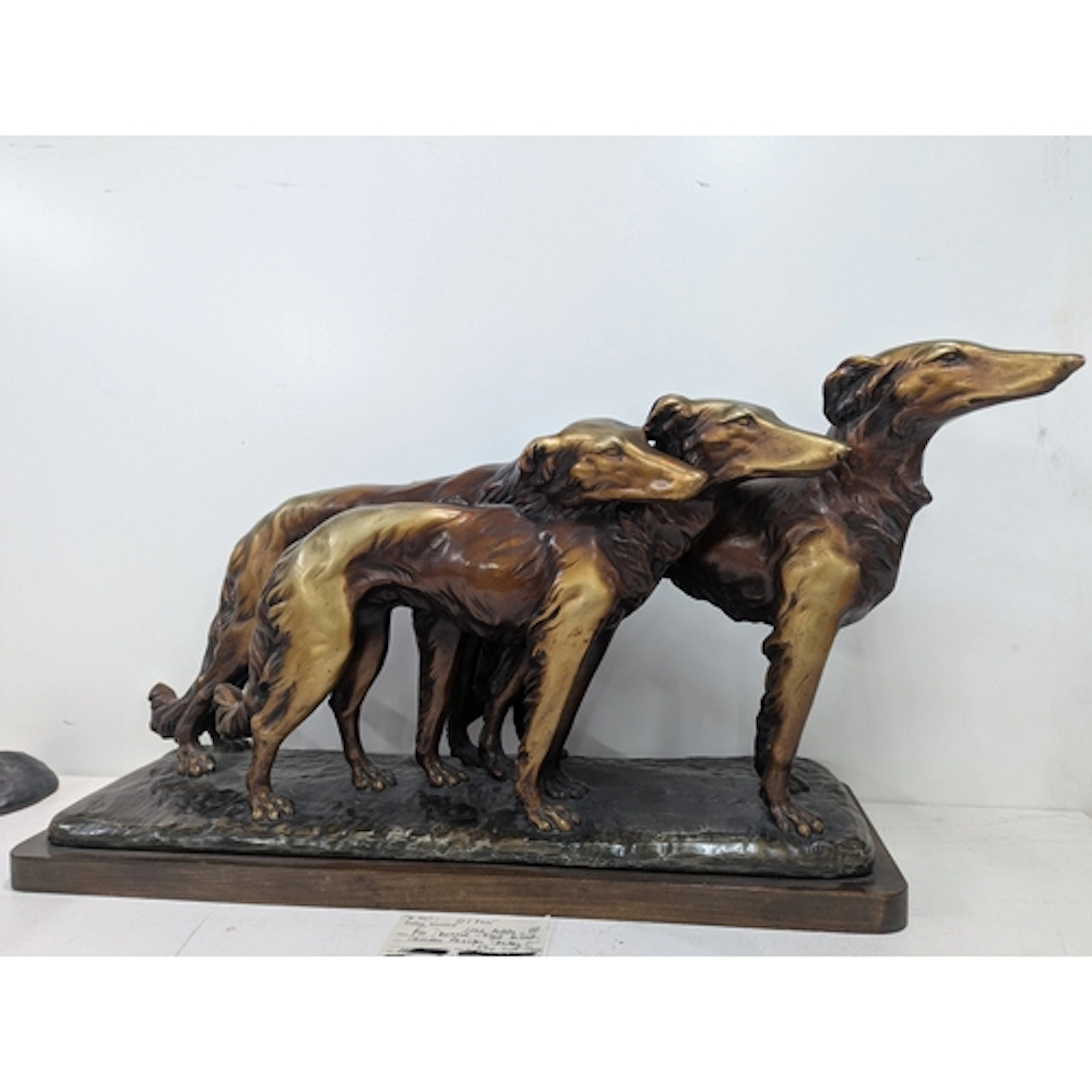 A large Art Deco Sculpture of three Borzoi in motion, in pla...