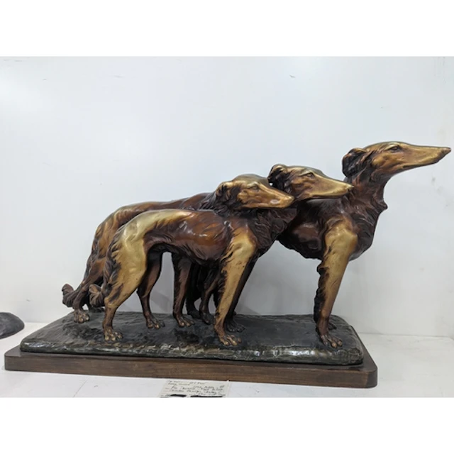 A large Art Deco Sculpture of three Borzoi in motion, in pla...