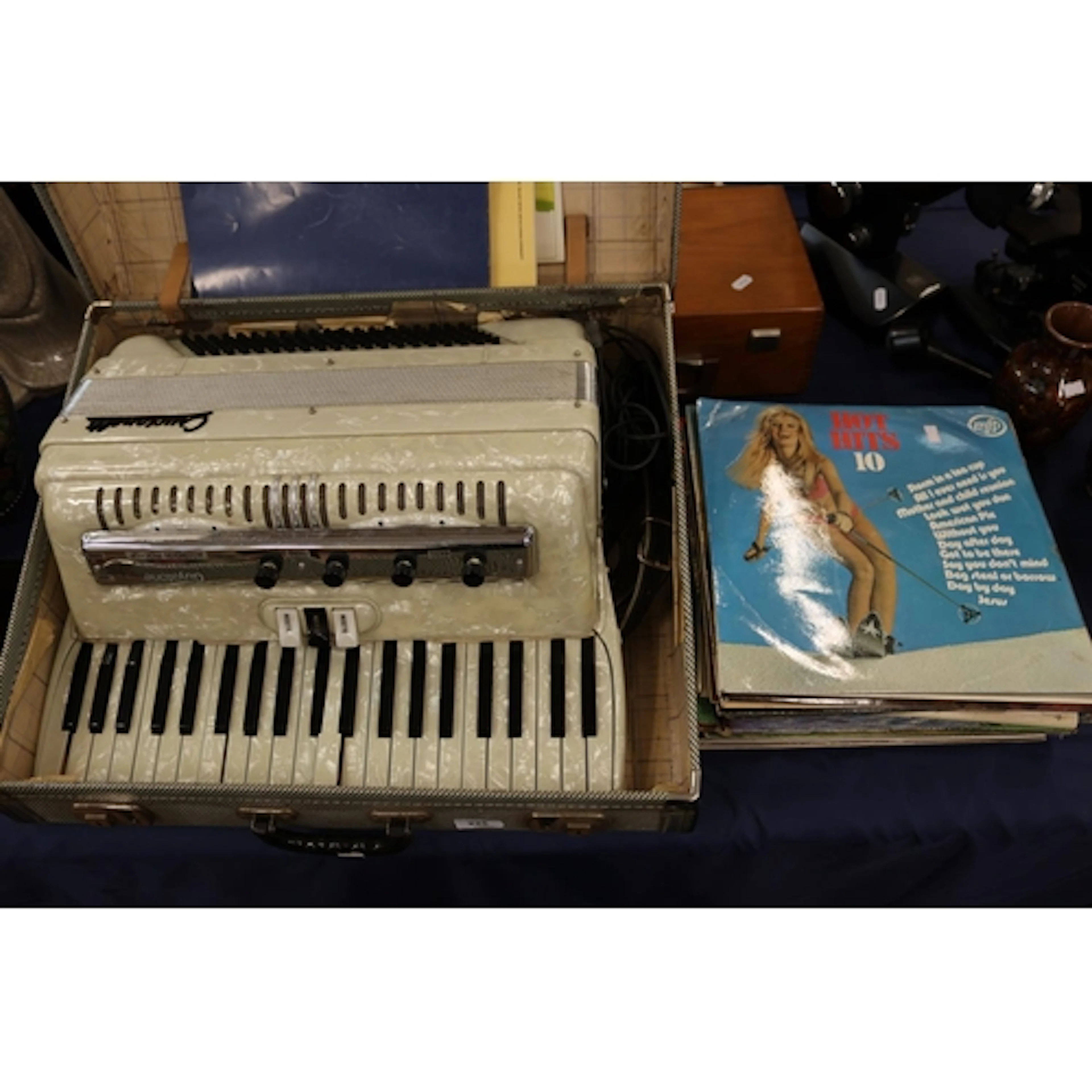 Vintage cased accordion and mixed vinyl records.