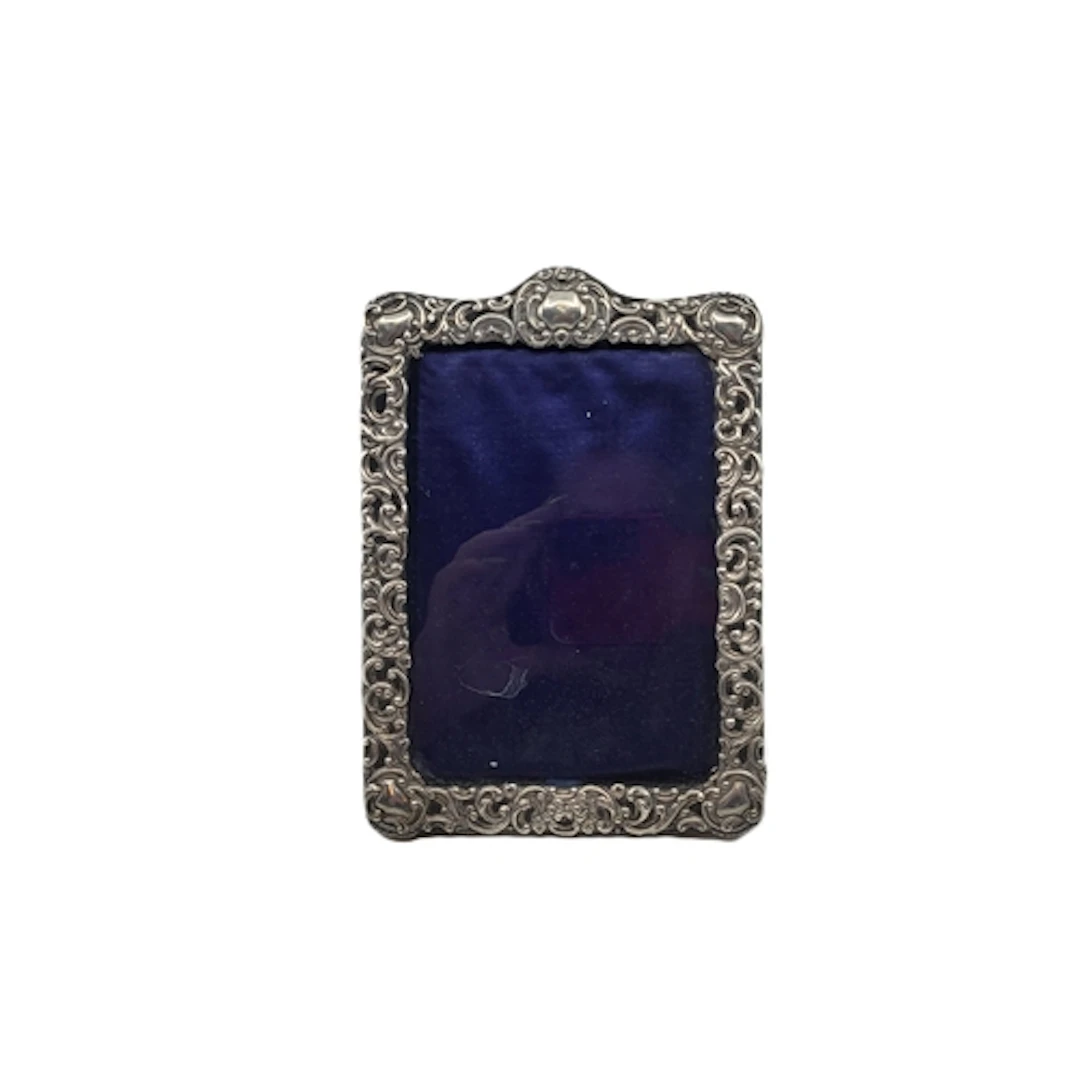 A SILVER EMBOSSED PHOTO FRAME