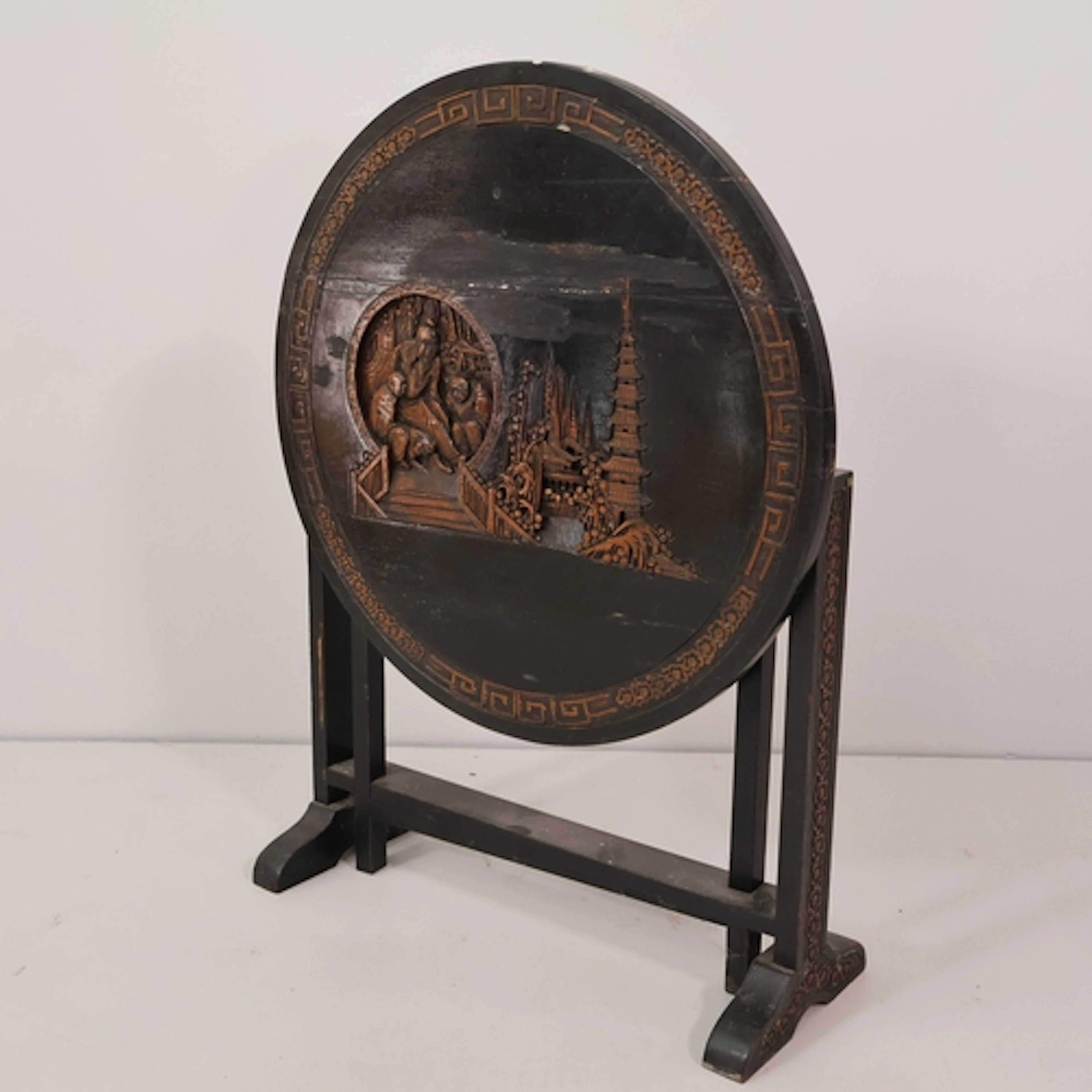 An antique Chinese ebonised circular tilt-top occasional tab...