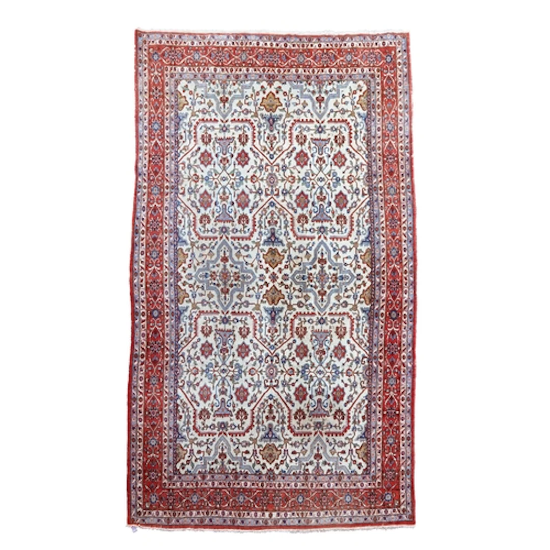 A Sarouk ivory ground carpet, the dense floral field within ...