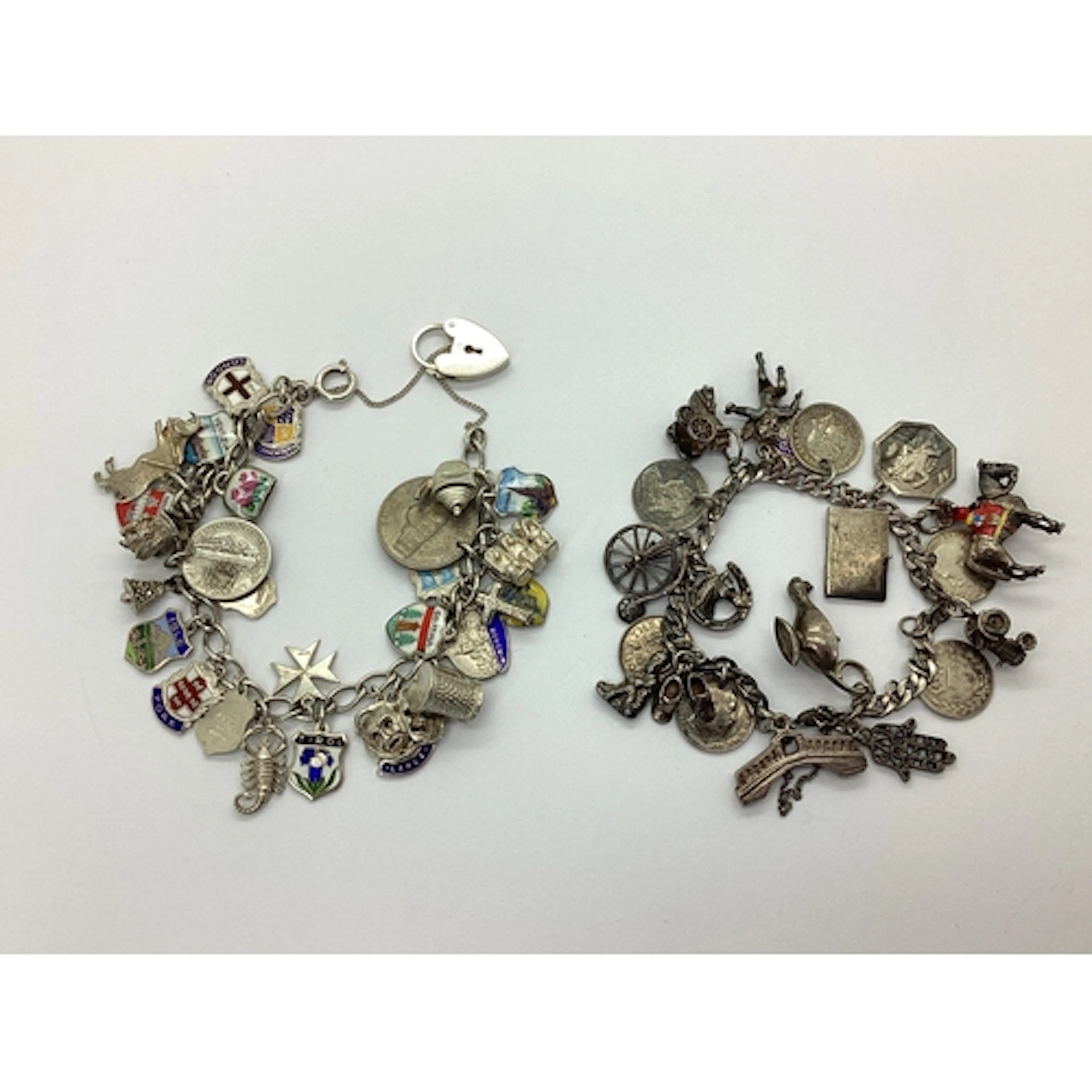 Two Curb Link Bracelets, suspending a quantity of assorted n...