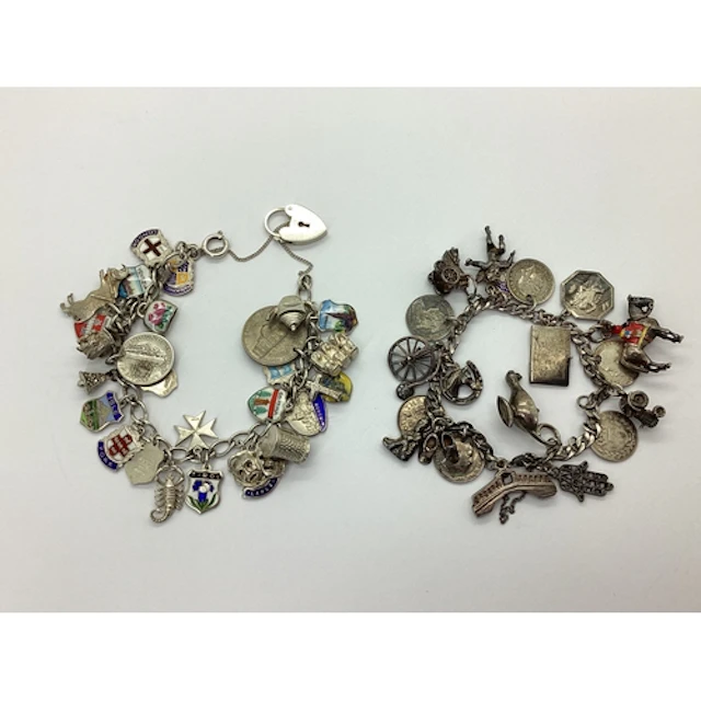 Two Curb Link Bracelets, suspending a quantity of assorted n...