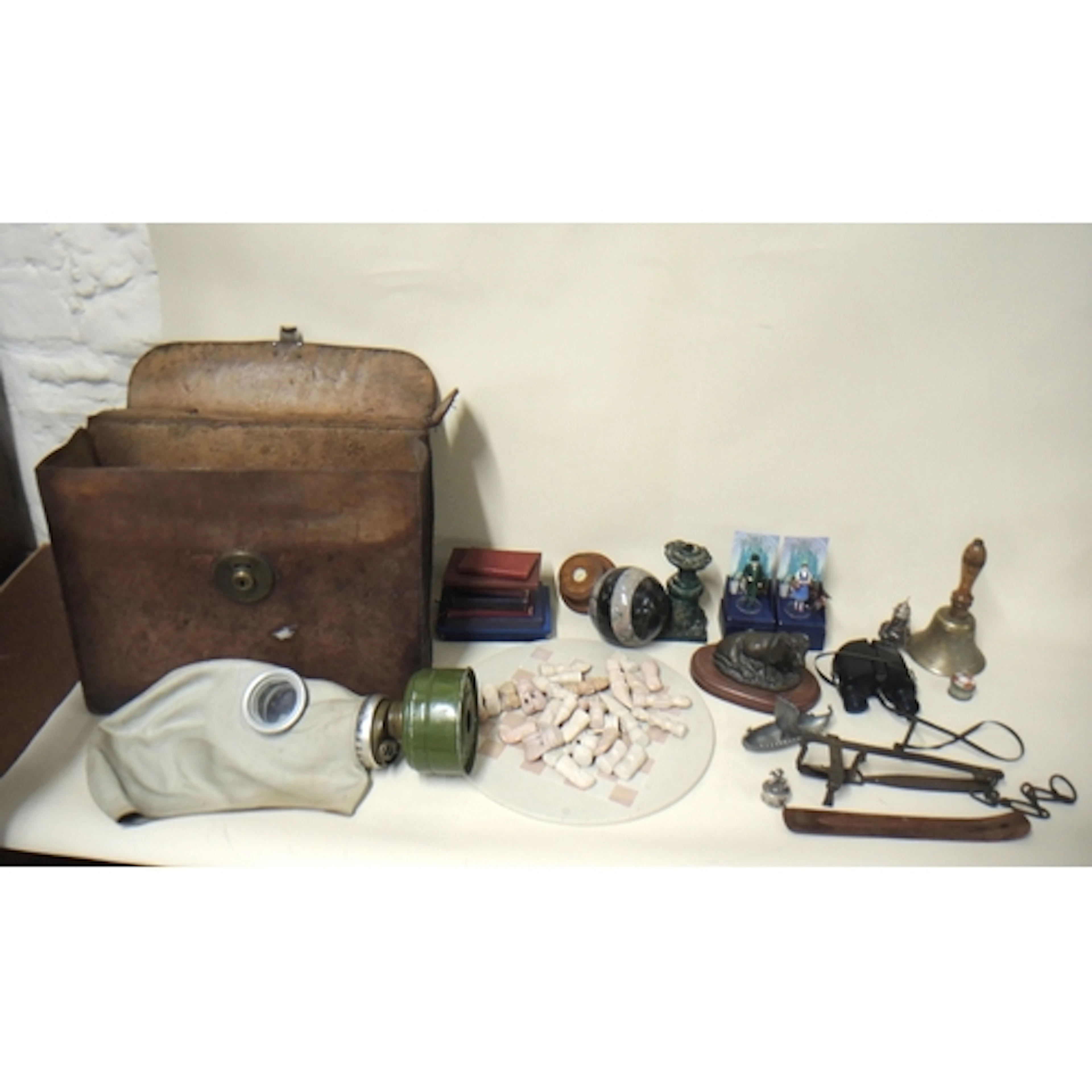 Antique leather case with brass lock stamped OBS, a gas mask...