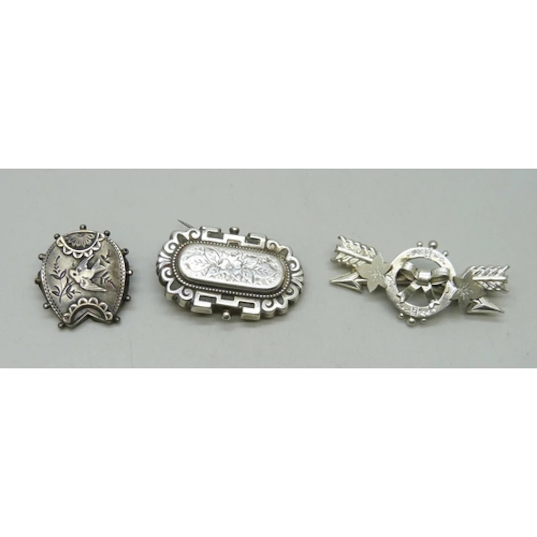 Three Victorian brooches including two hallmarked silver and...