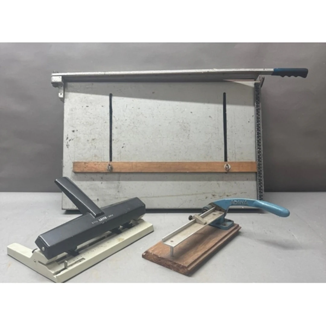 A portable drafting board with attached guillotine and two o...