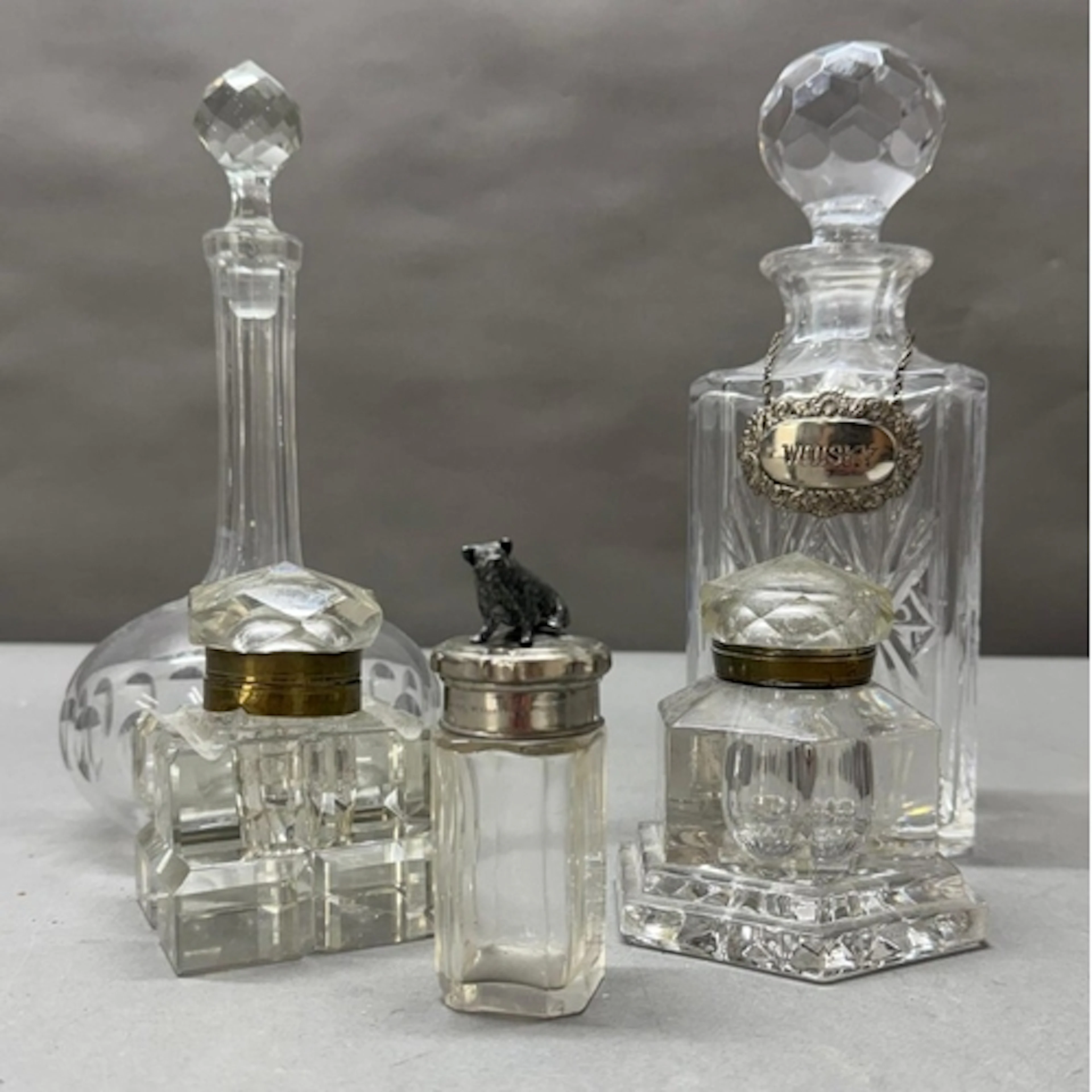 A selection of cut glass decanters and ink wells together wi...