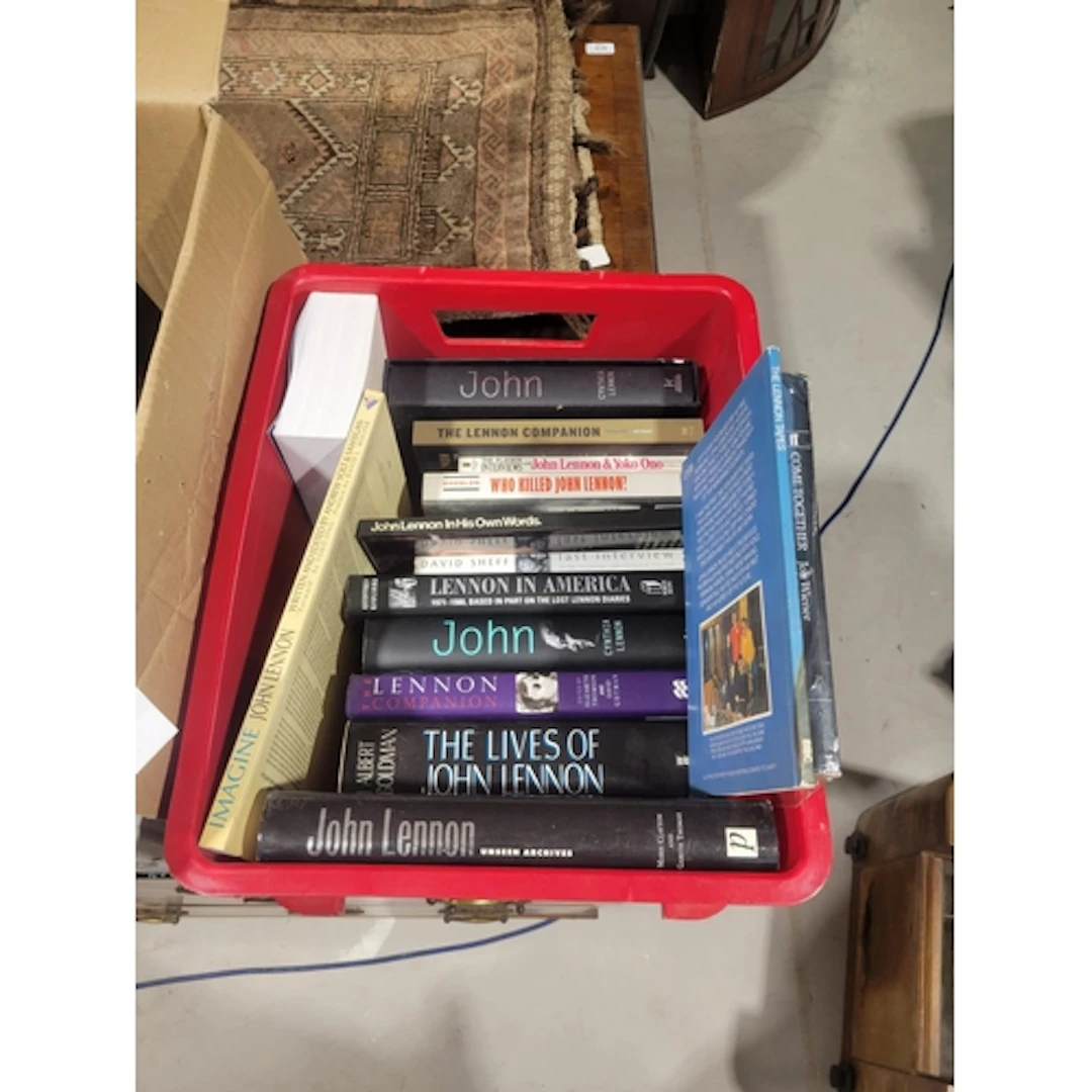 Box containing John Lennon hardback and paperback books.