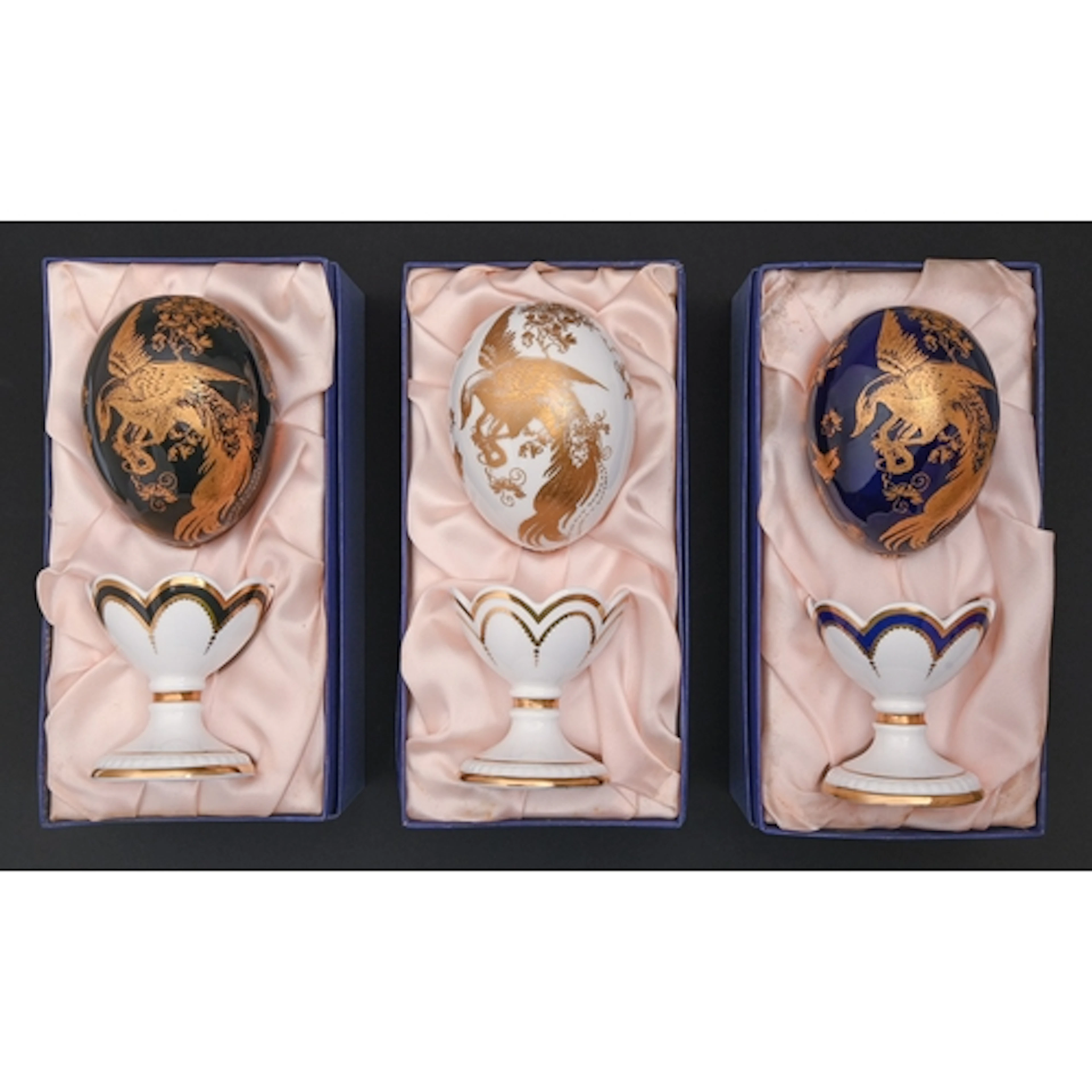 A set of three Royal Crown Derby 'Faberge Eggs' and stands, ...