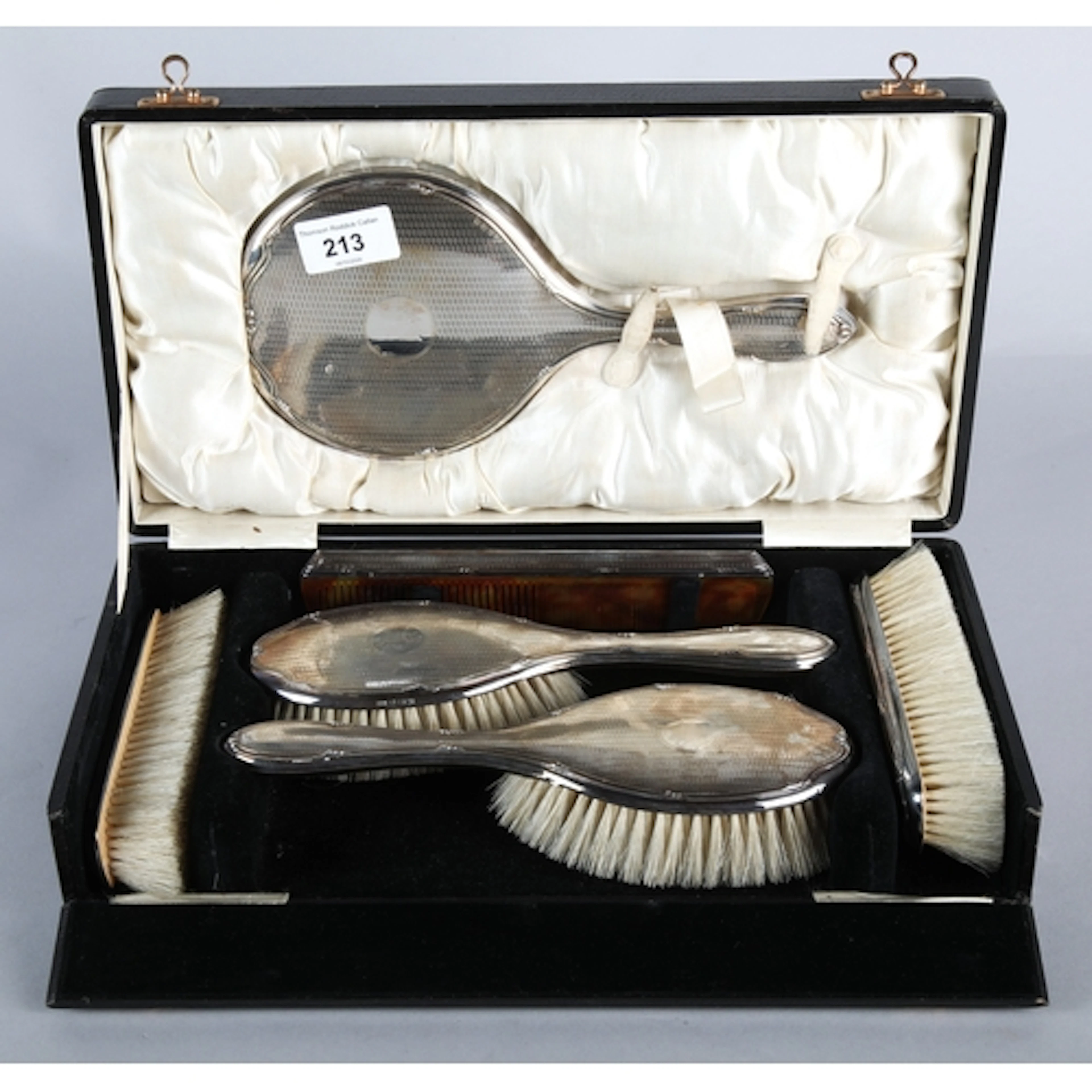 Silver backed vanity set to include a hand mirror, two hair ...