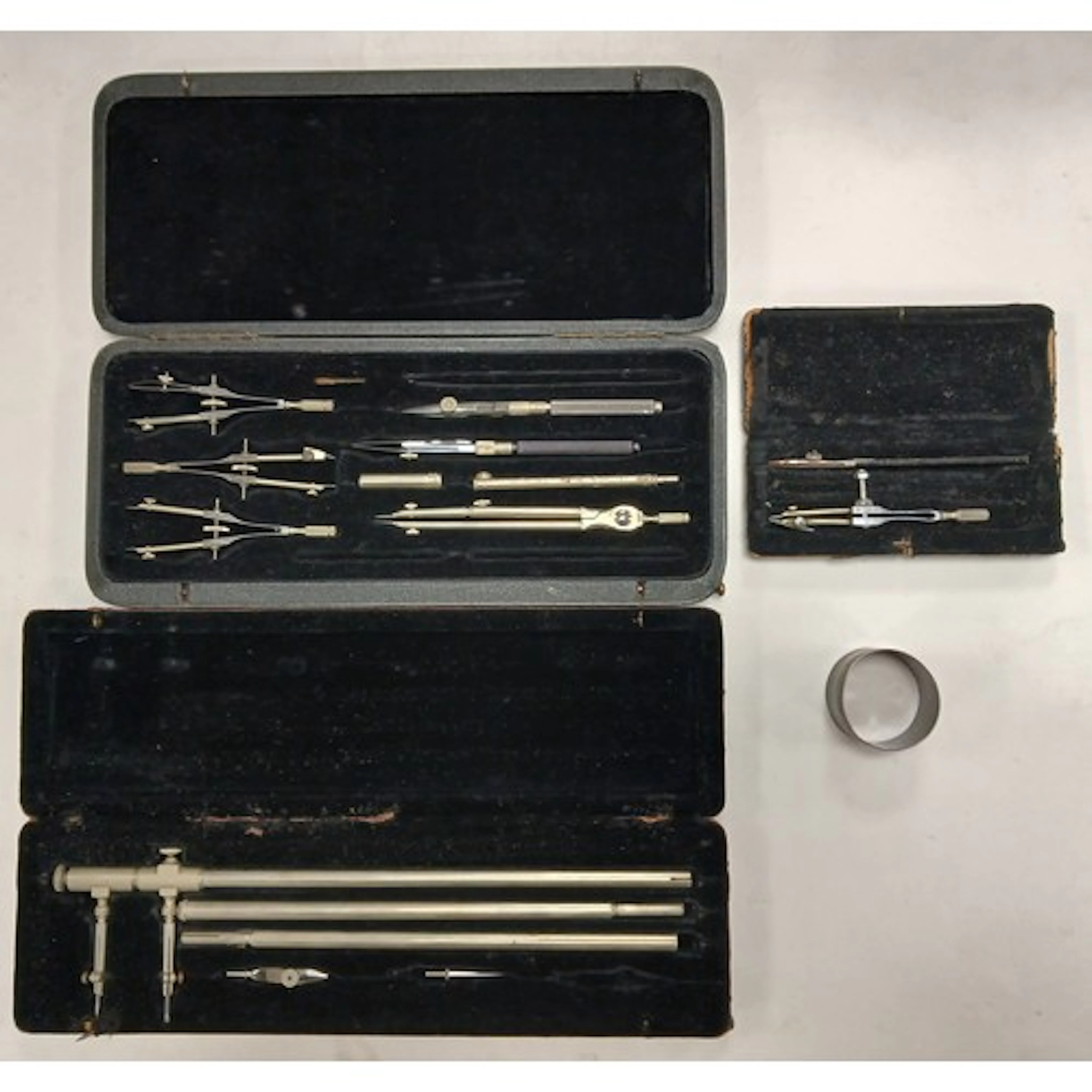 Various cased drawing instruments, and a napkin ring.