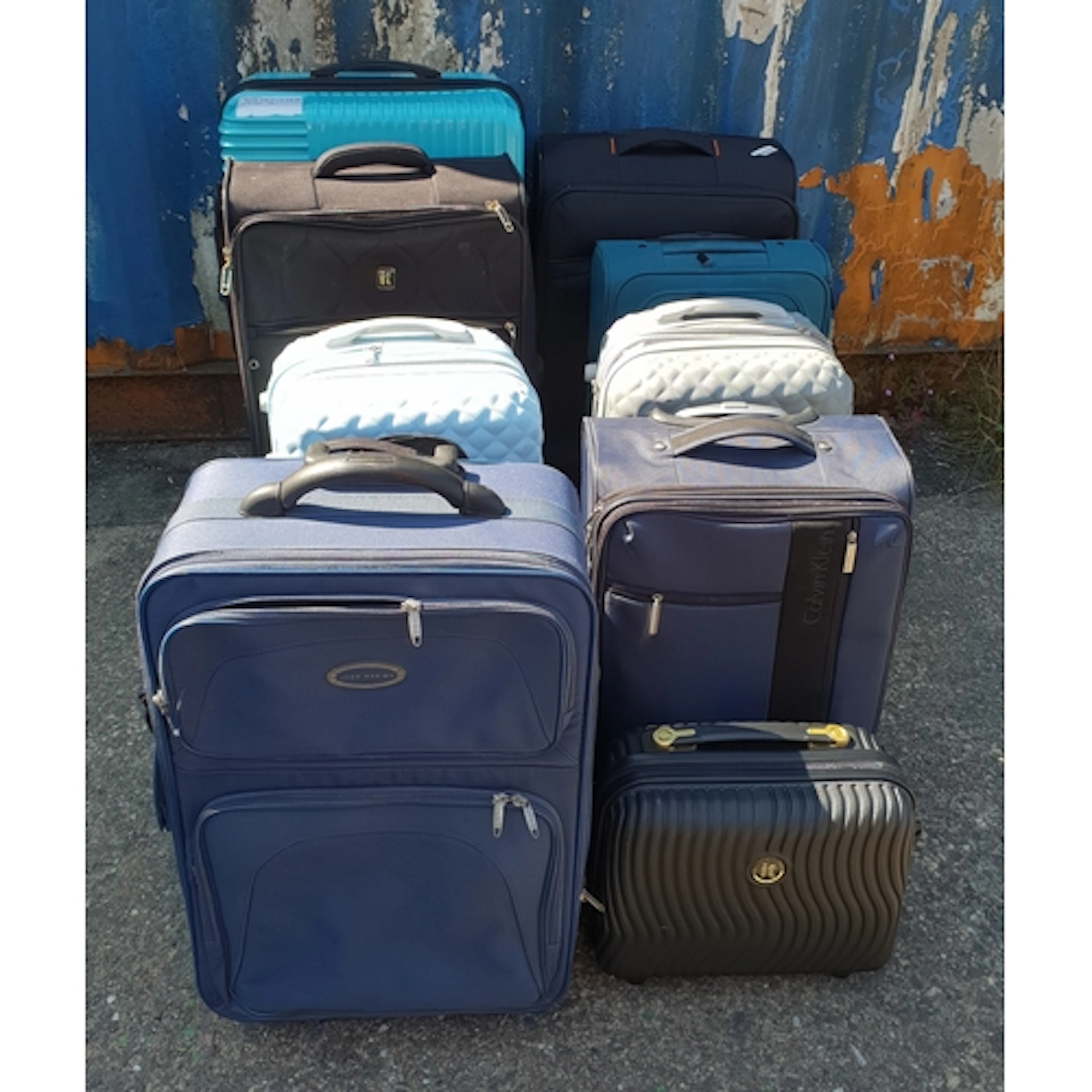 SELECTION OF TEN SUITCASES including J Design, Calvin Clein,...