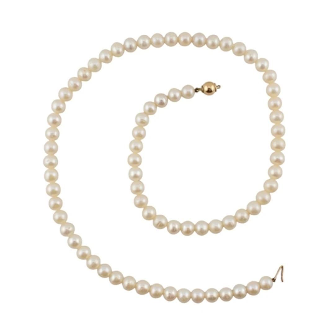 A 14ct gold cultured pearl single strand necklace. The clasp...