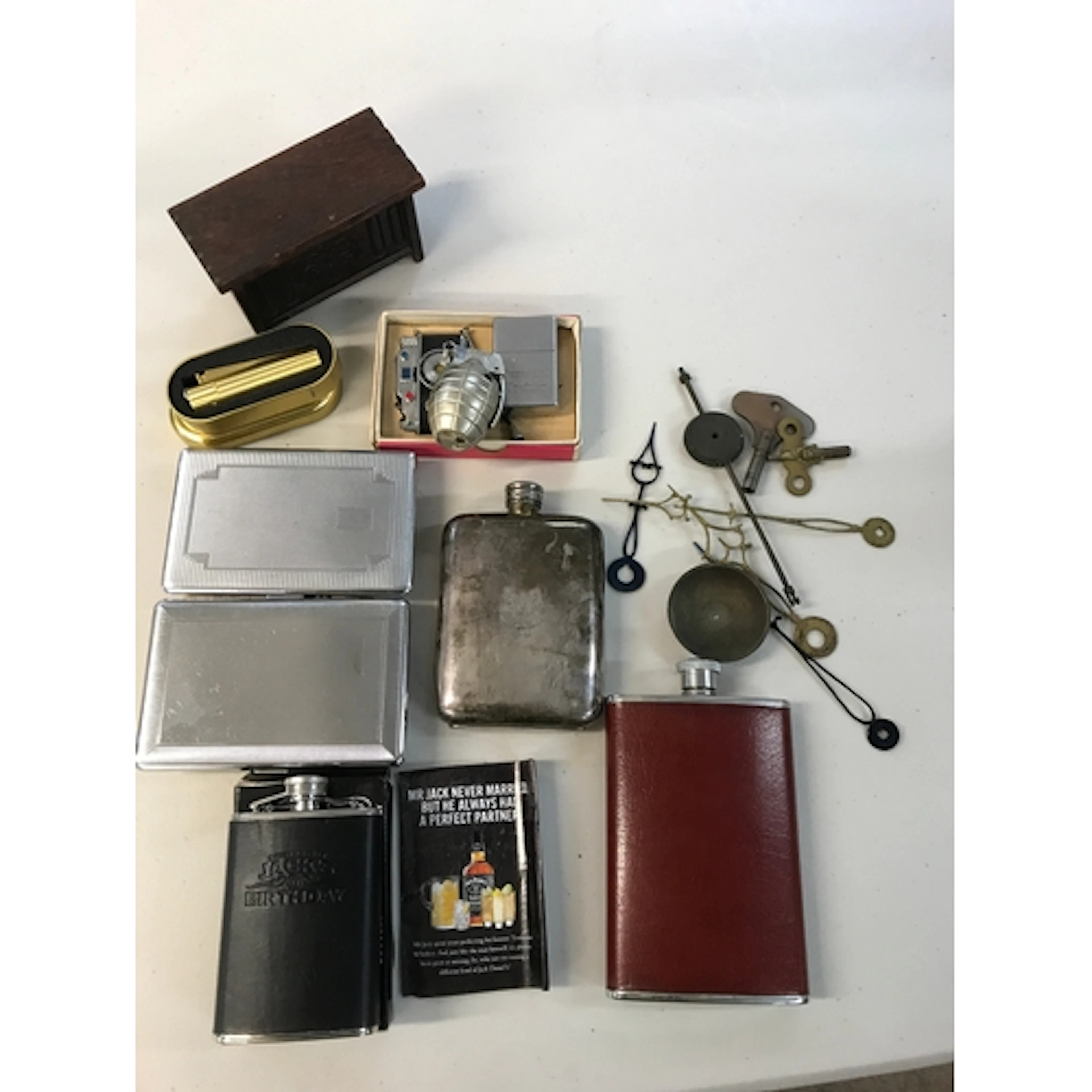 A collection of hip flasks and lighters including a novelty ...