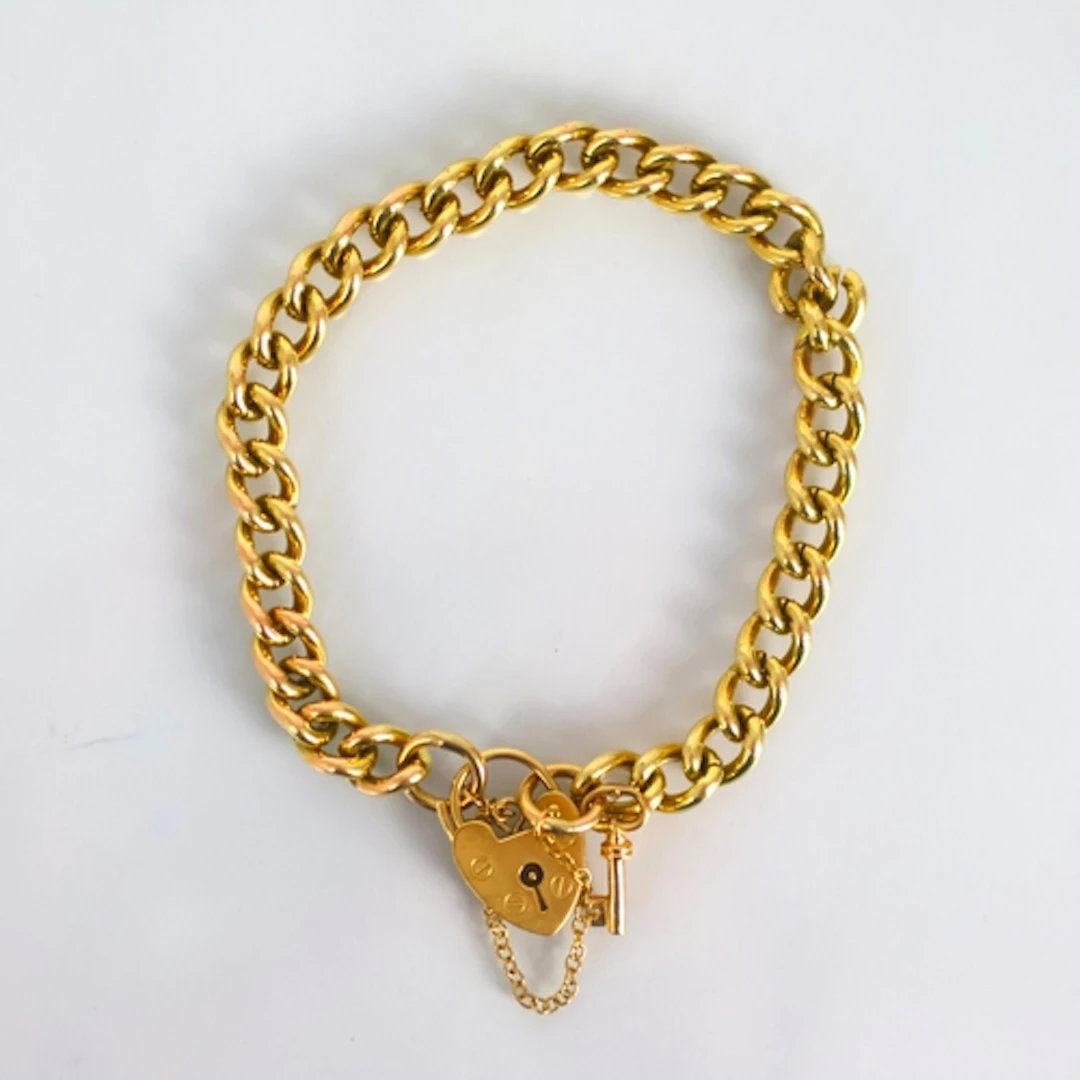 An early 20th century style yellow metal bracelet, the curb ...