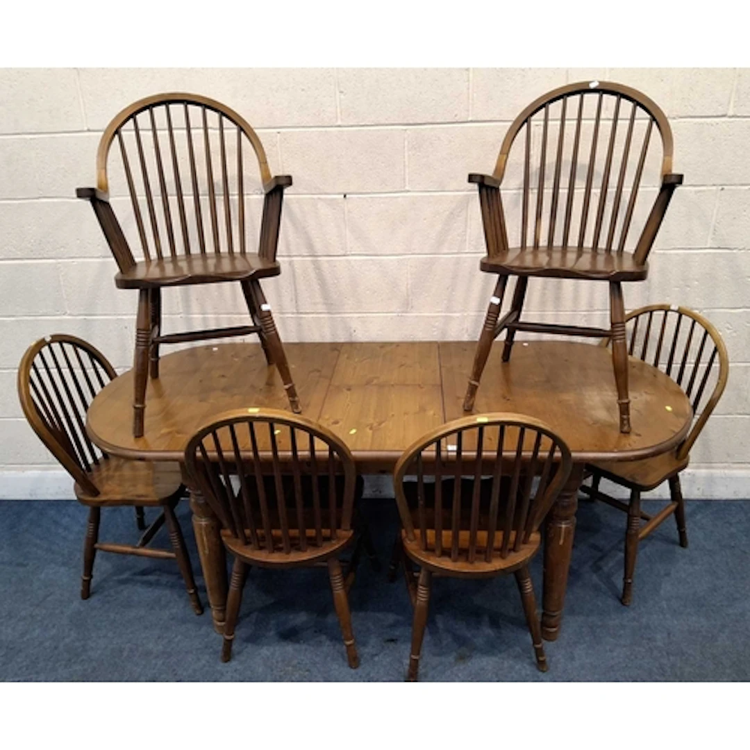 A MODERN DUCAL PINE OVAL EXTENDING DINING TABLE, with a sing...