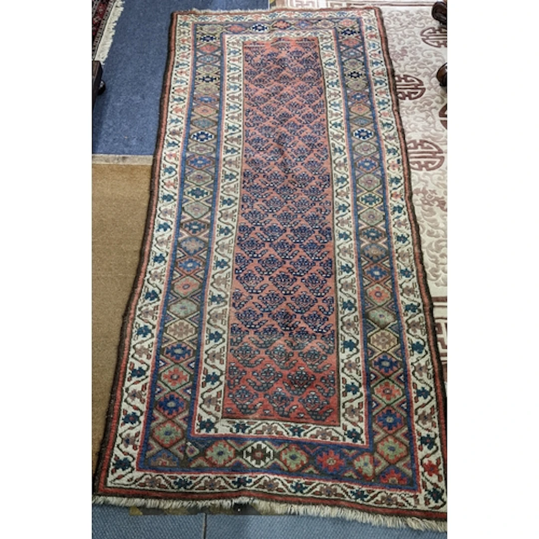 A Persian hand woven rug having a red field decorated with g...