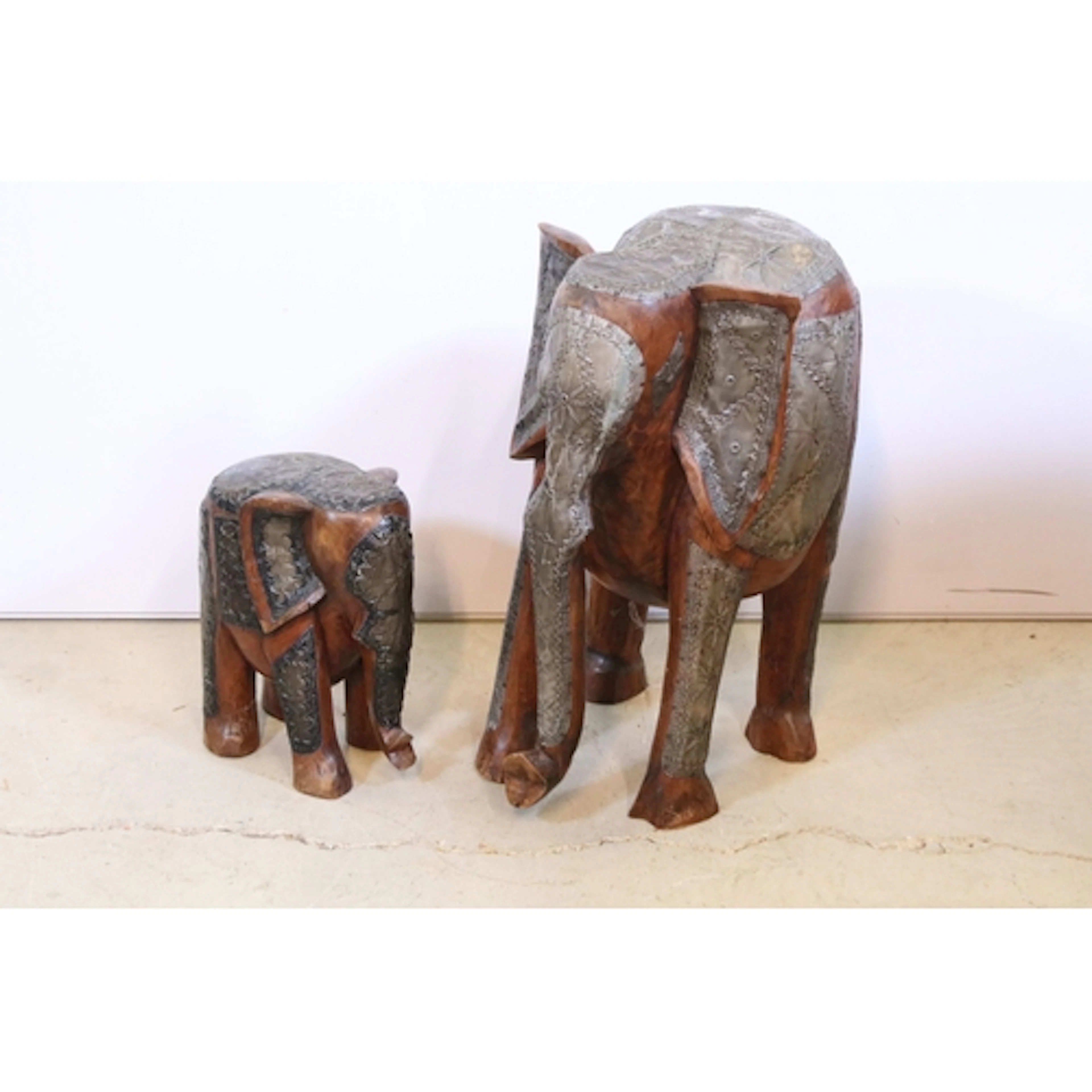 Two 20th century hardwood figures of elephants, onset with e...