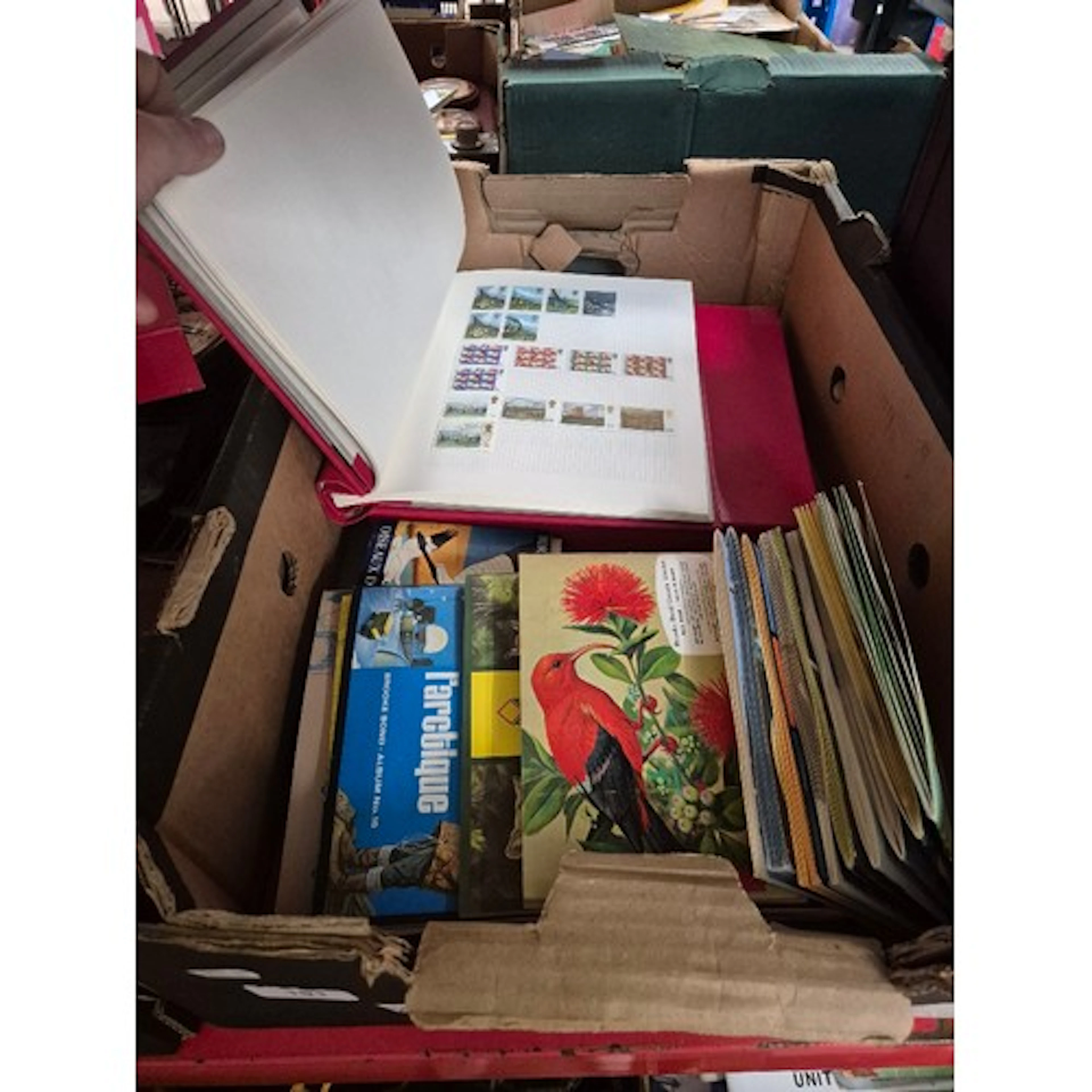 A box of assorted collector card set & two stamp albums.