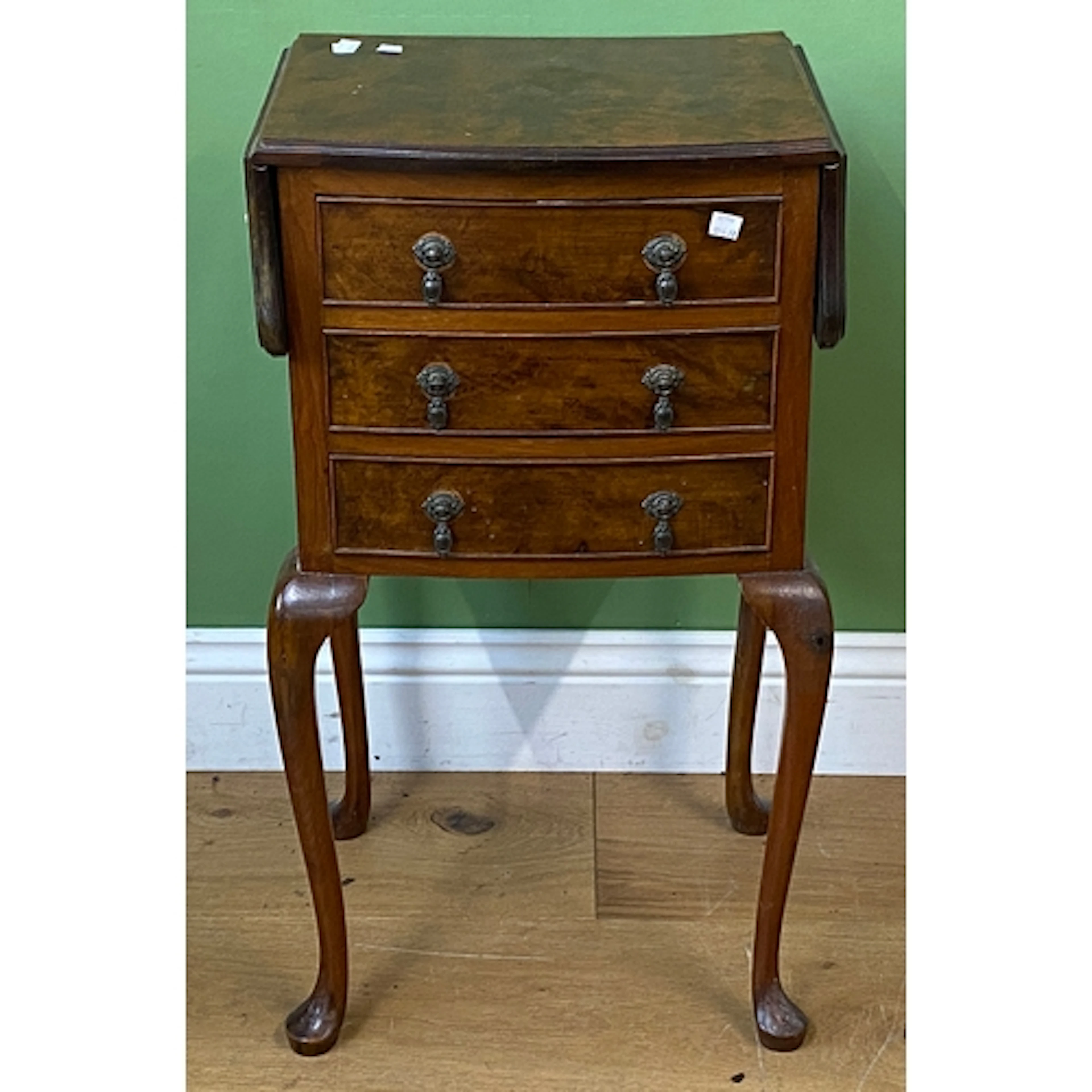 A 20th century walnut occasional or bedside table of three d...