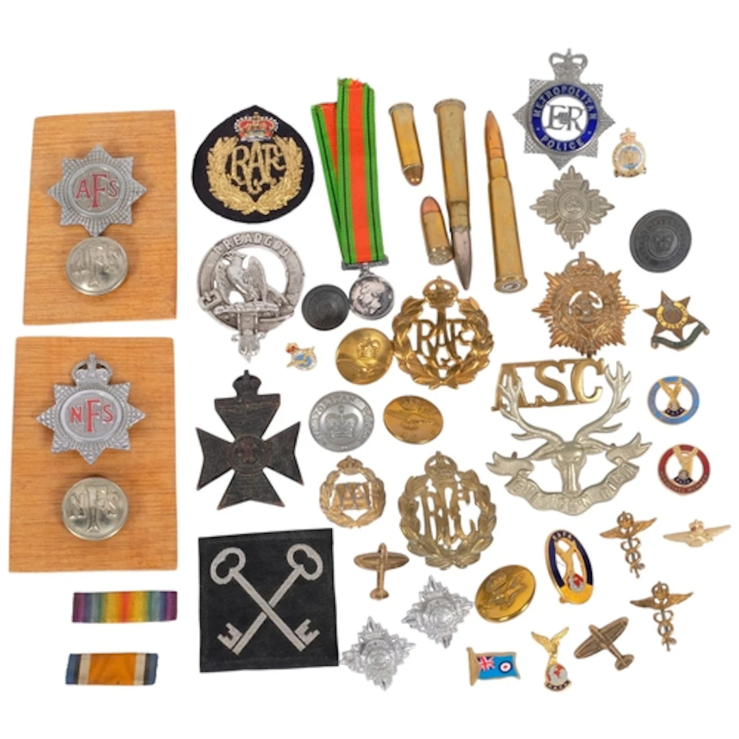 A collection of military badges, medals, etc