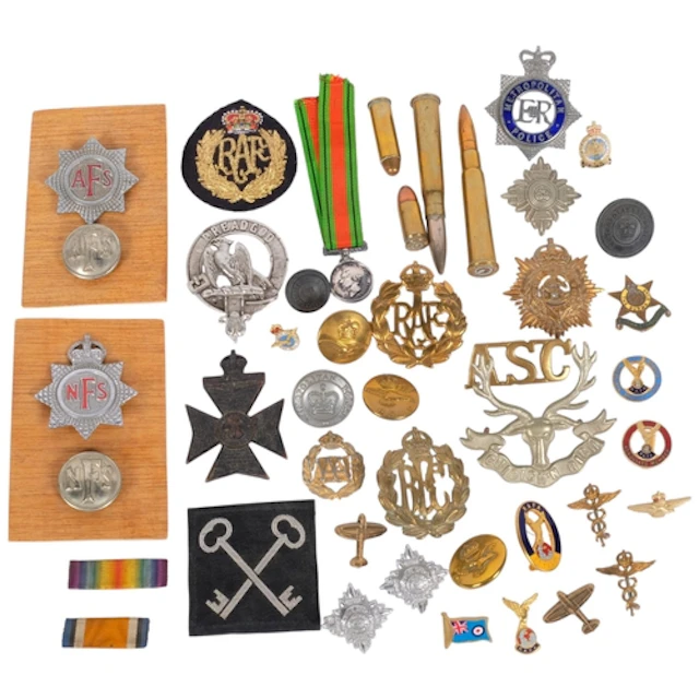 A collection of military badges, medals, etc