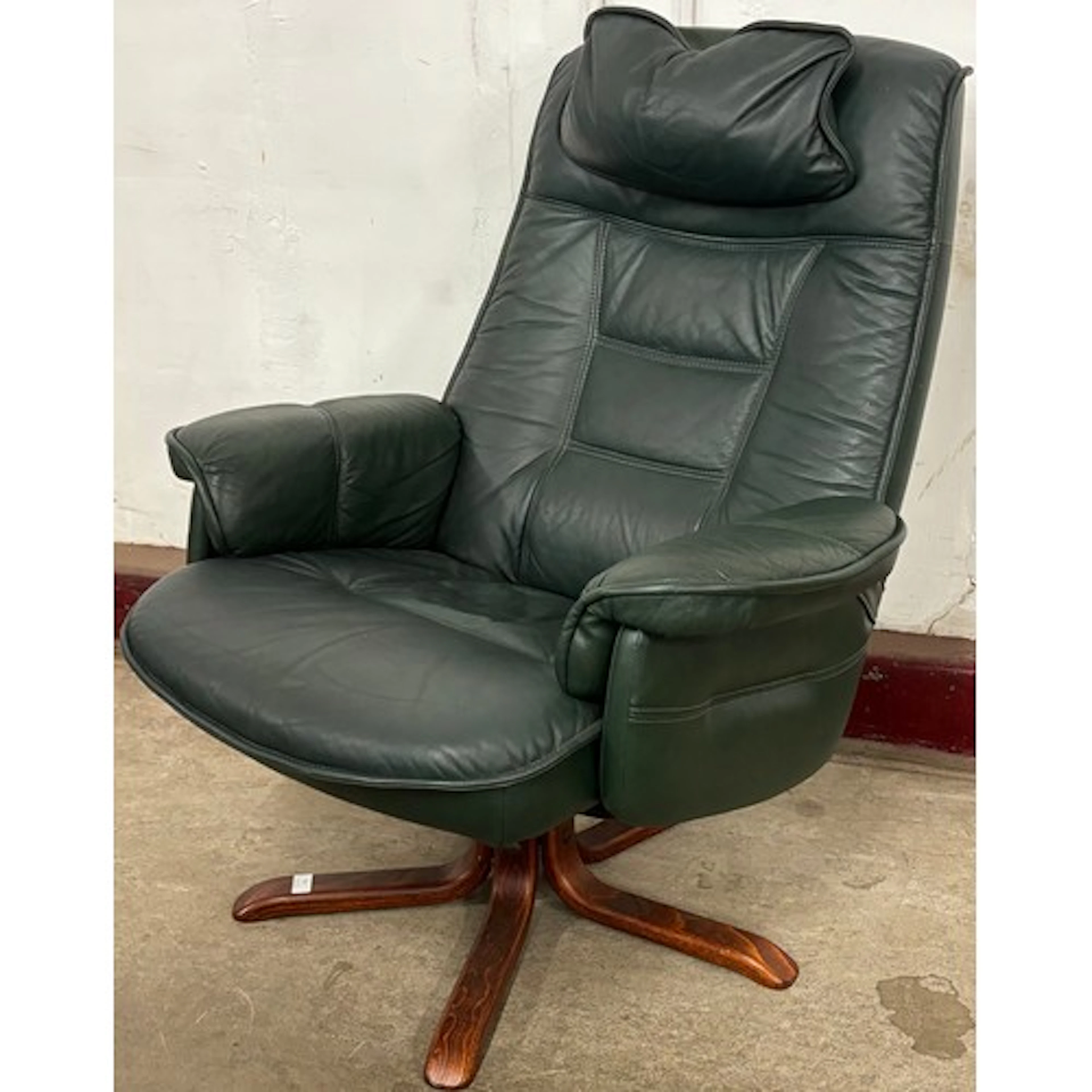 A green leather and beech revolving lounge chair