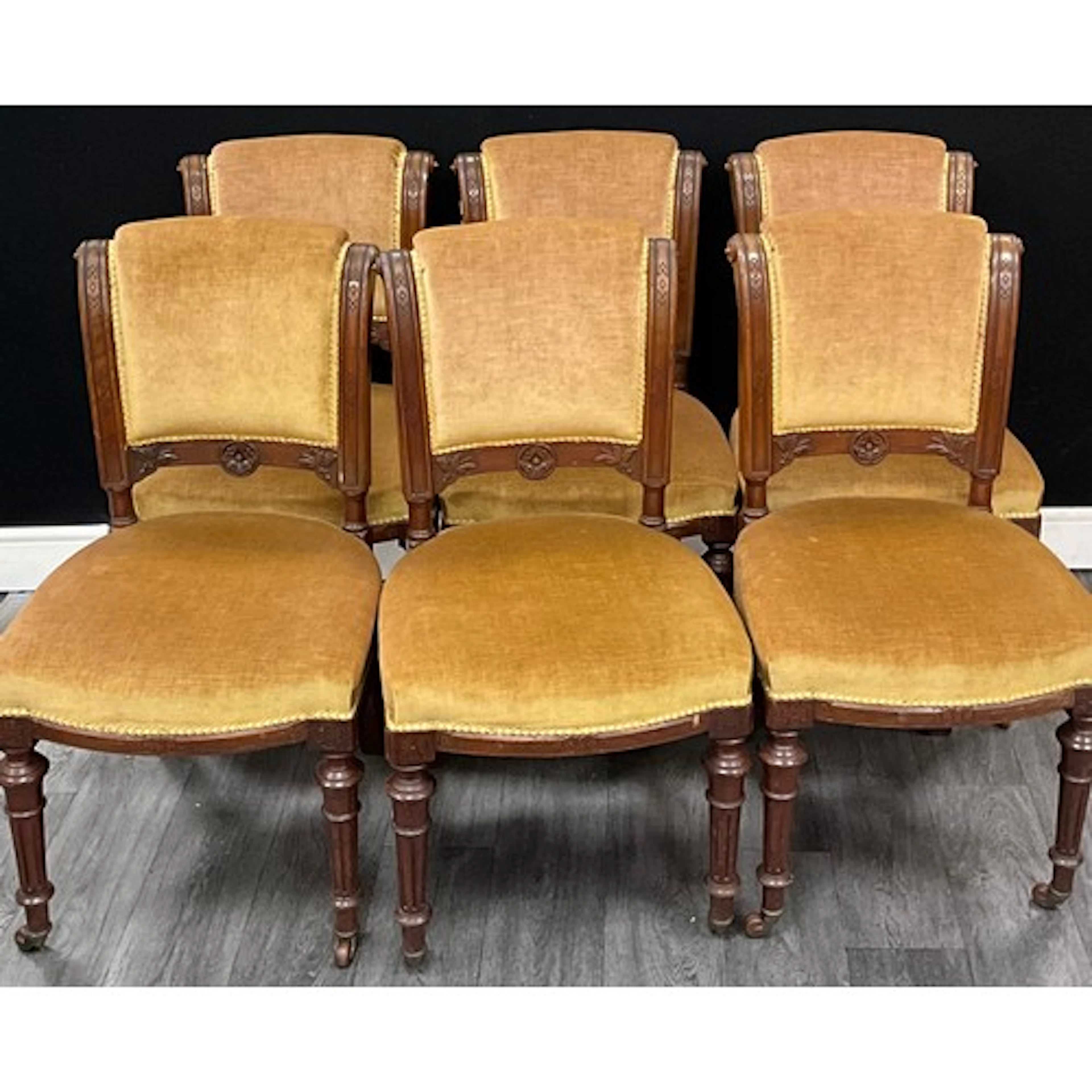 A set of six Victorian walnut side chairs, stuffed-over back...