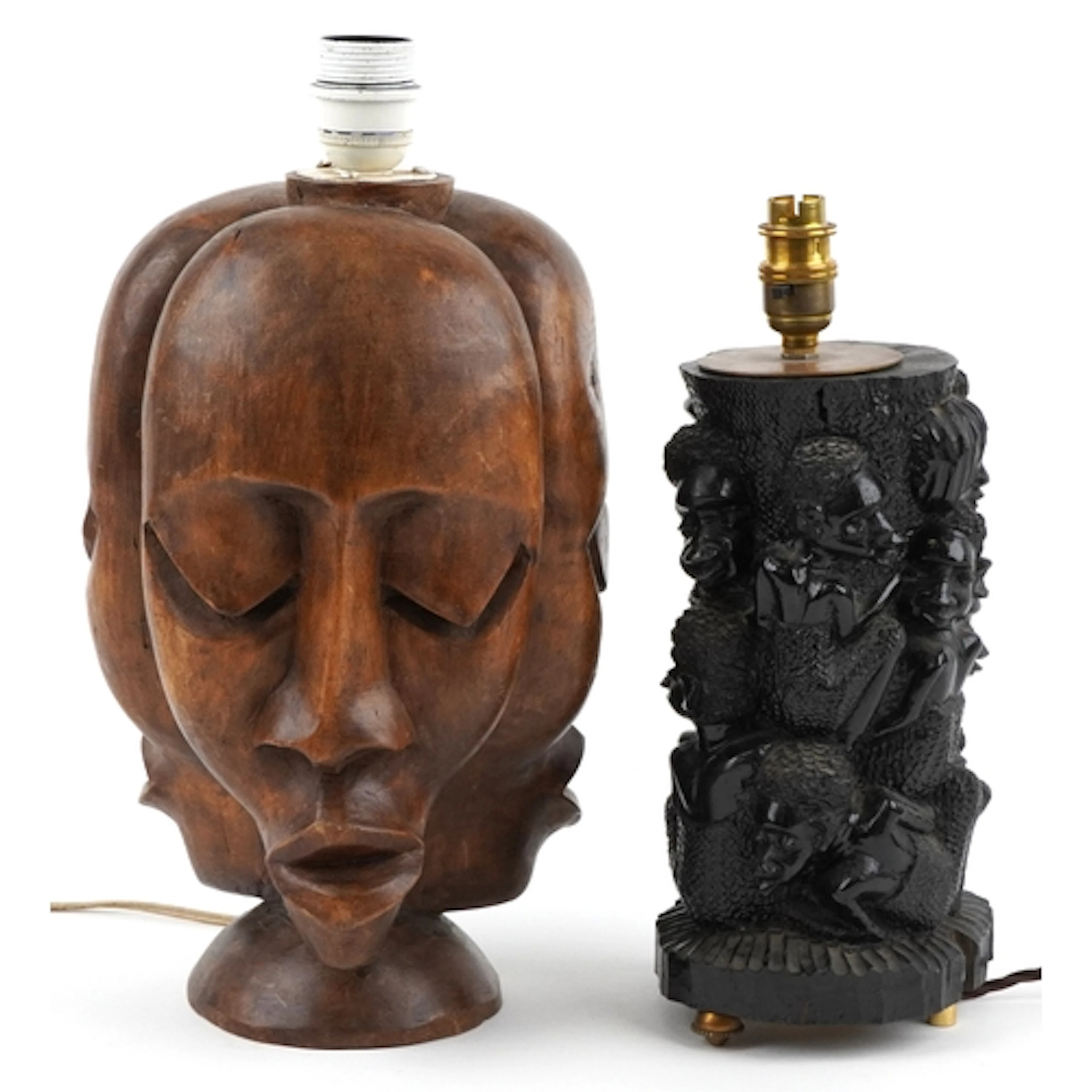 Two African hand figural table lamps, one carved with three ...