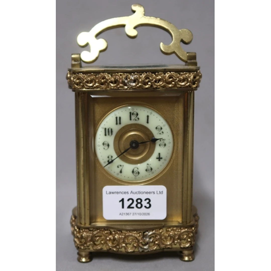 Edwardian gilt brass carriage clock, the shaped case with ap...