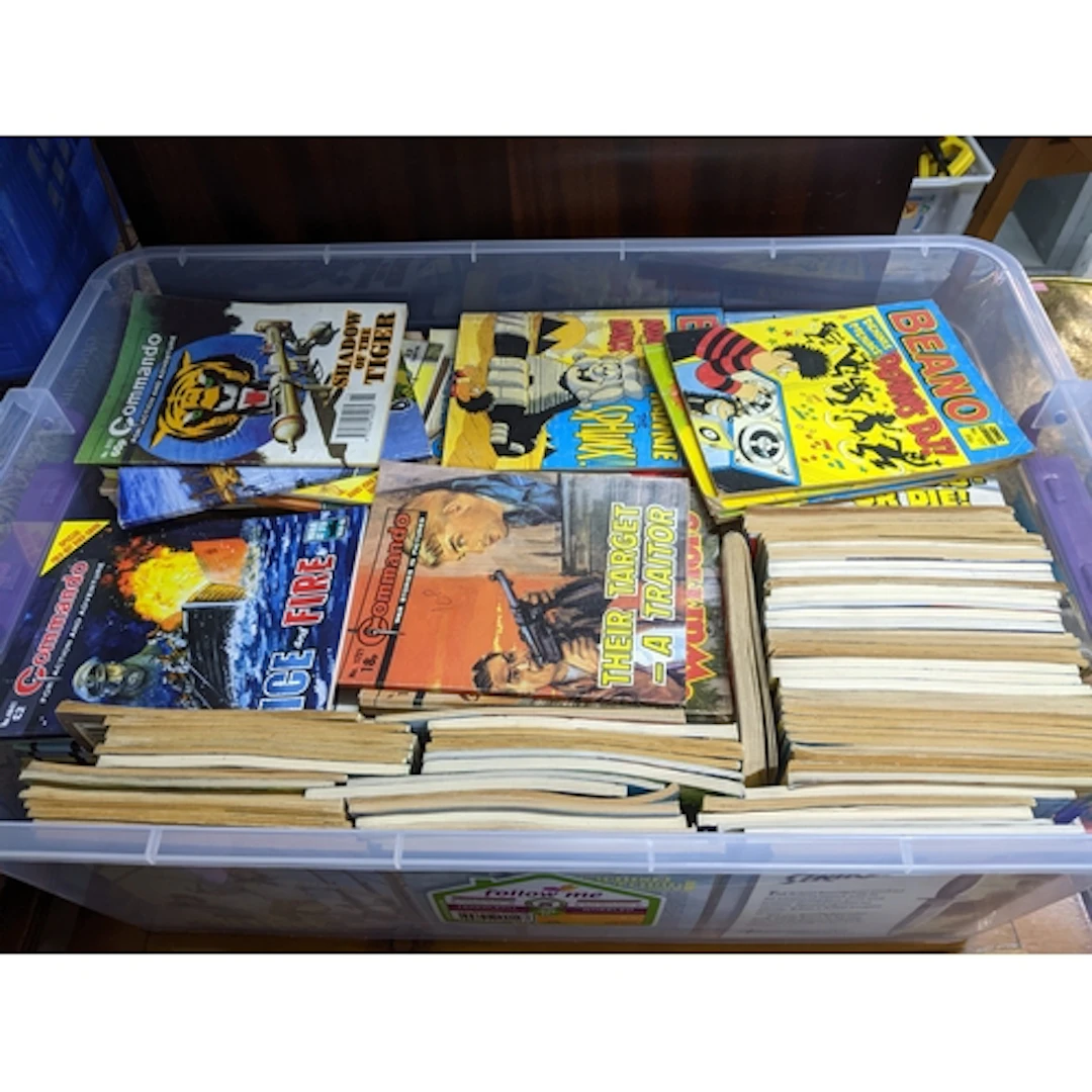 A box containing Commando. Air Ace, and Beano comics; along ...