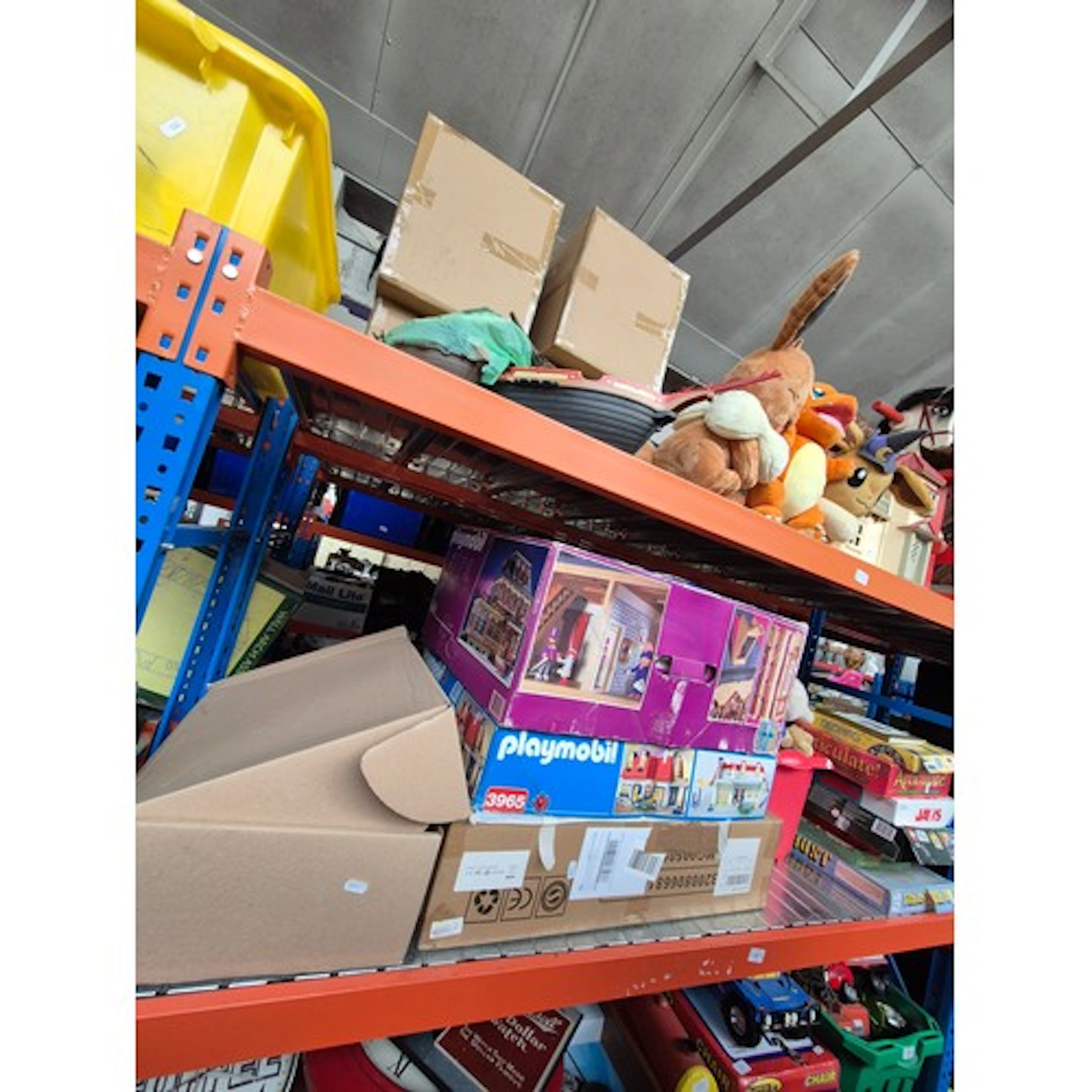 2 shelves of boxed games and toys including Playmobil, soft ...