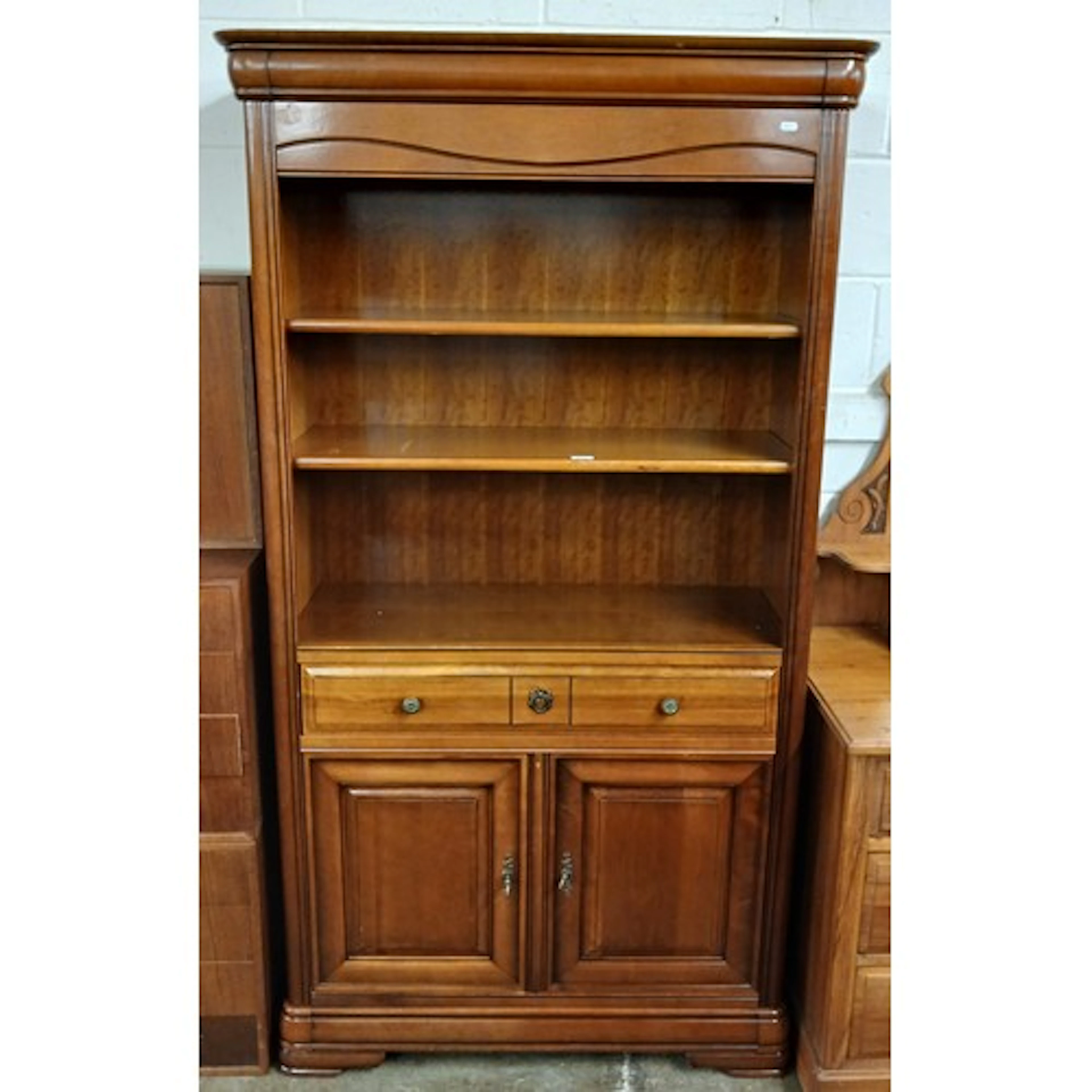 Contemporary unit open shelves over single drawer and cupboa...