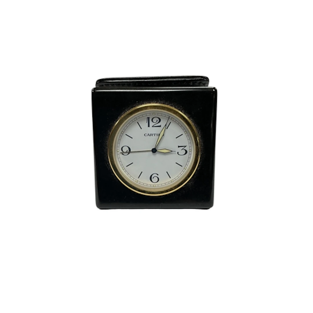 A Cartier Panthere travel clock, ref. 011426HF, attached to ...