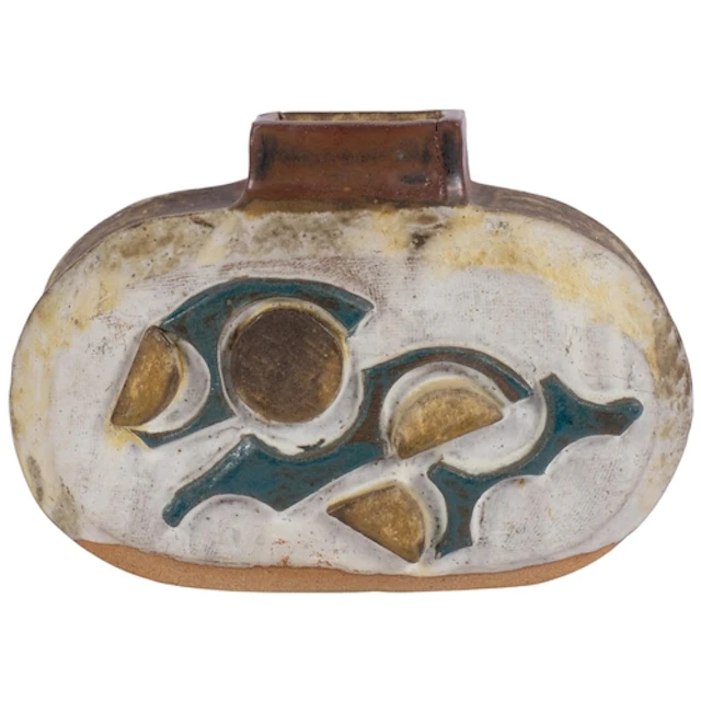 A heavy embossed and painted stoneware vase with abstract de...