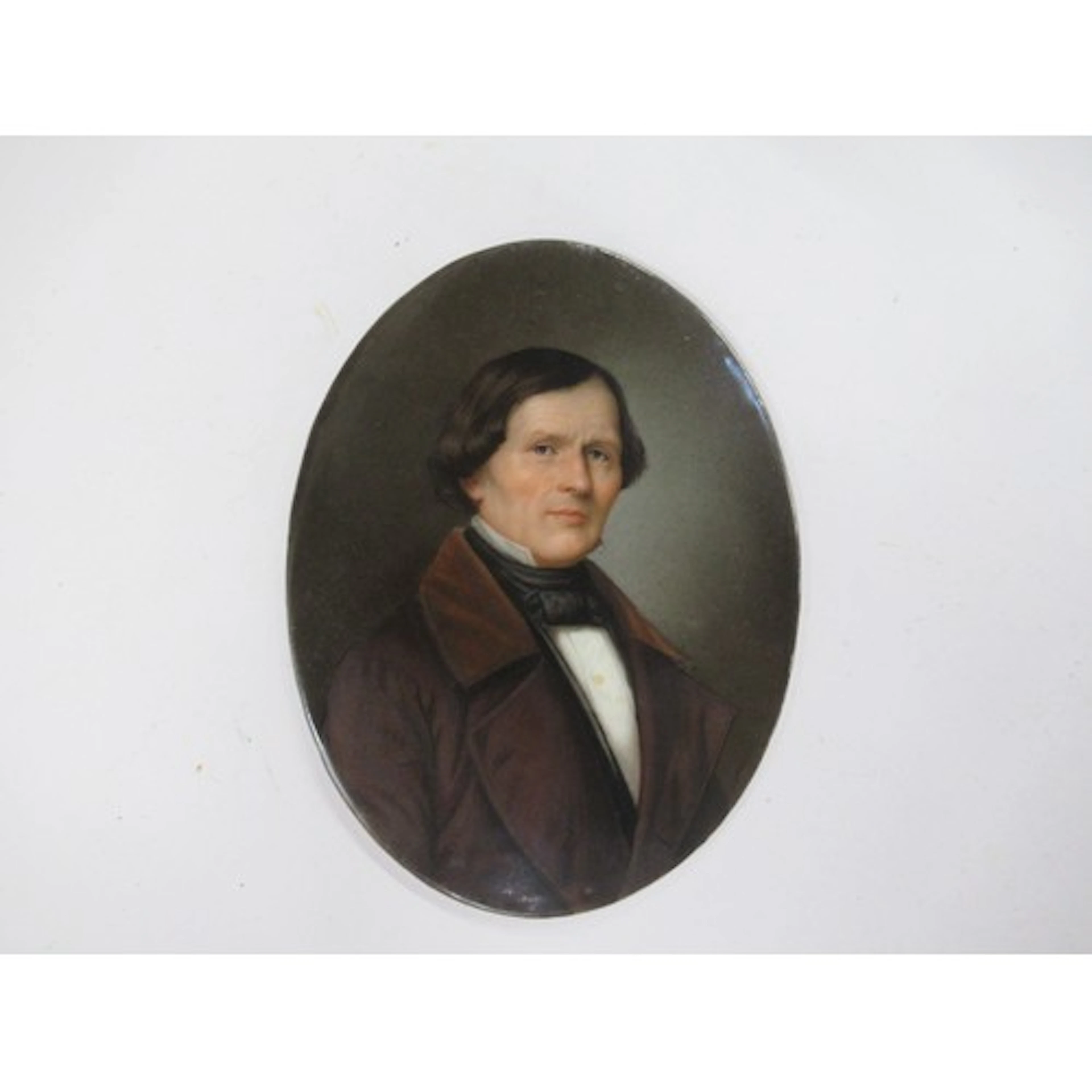 An antique oval porcelain panel, painted with a portrait of ...