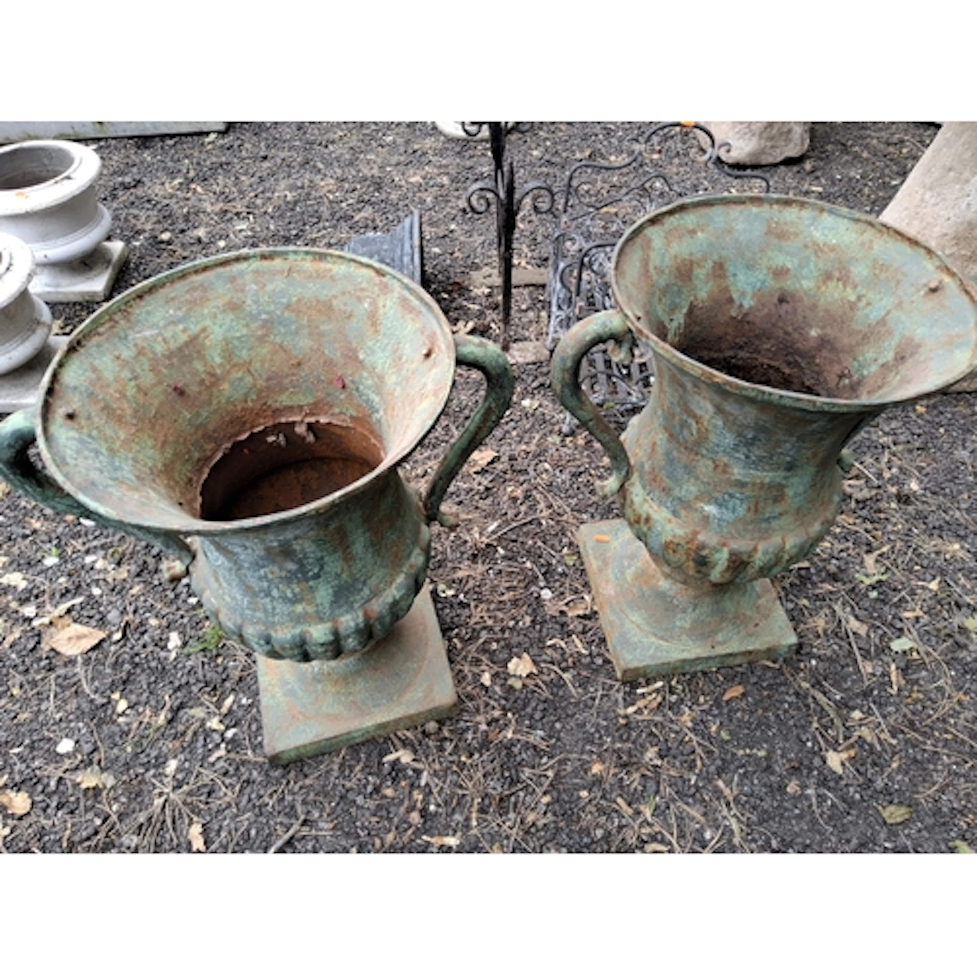 A PAIR OF CAST IRON CAMPAGNA URNS, with handles and fluted d...