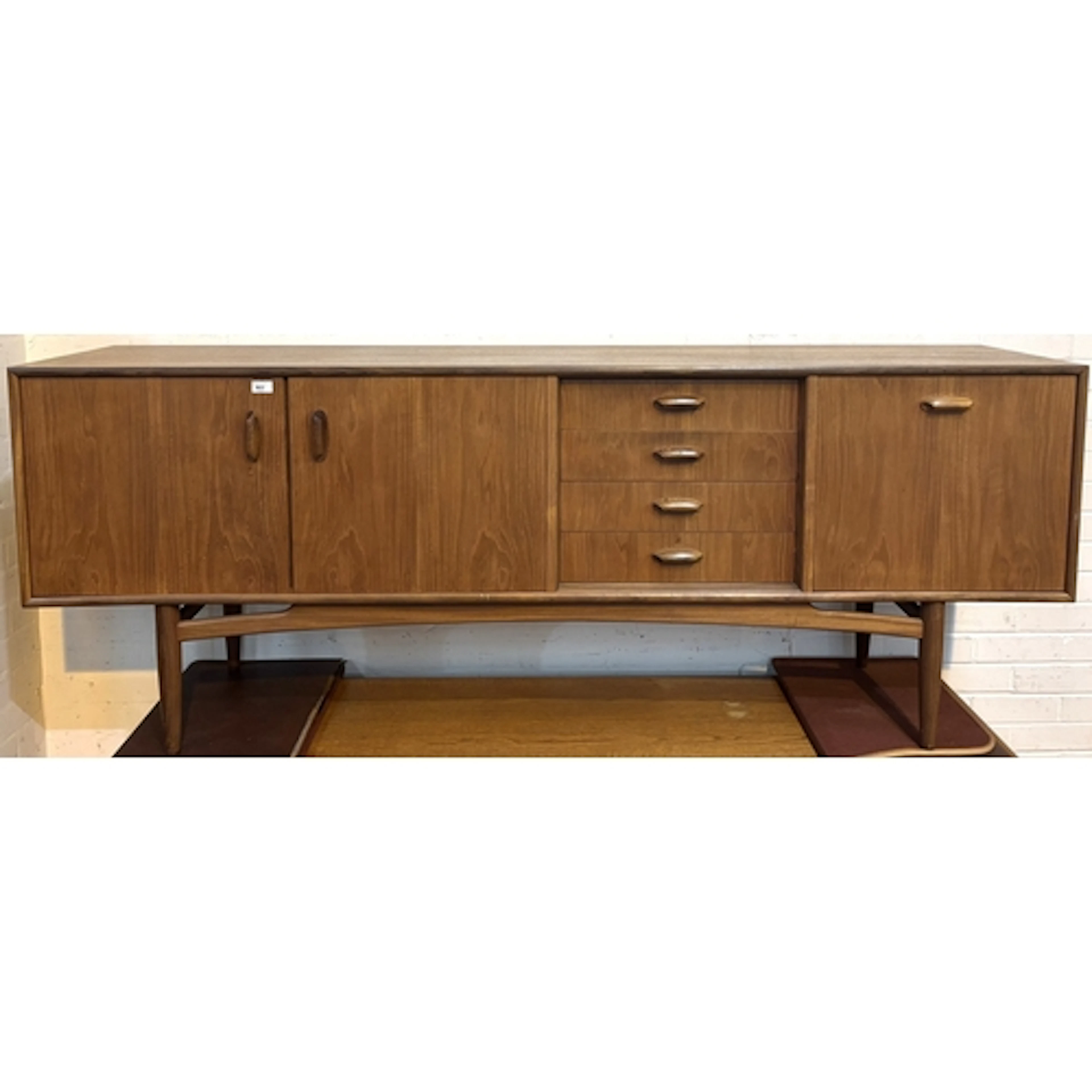 A Victor Wilkins for G-Plan teak mid century sideboard featu...