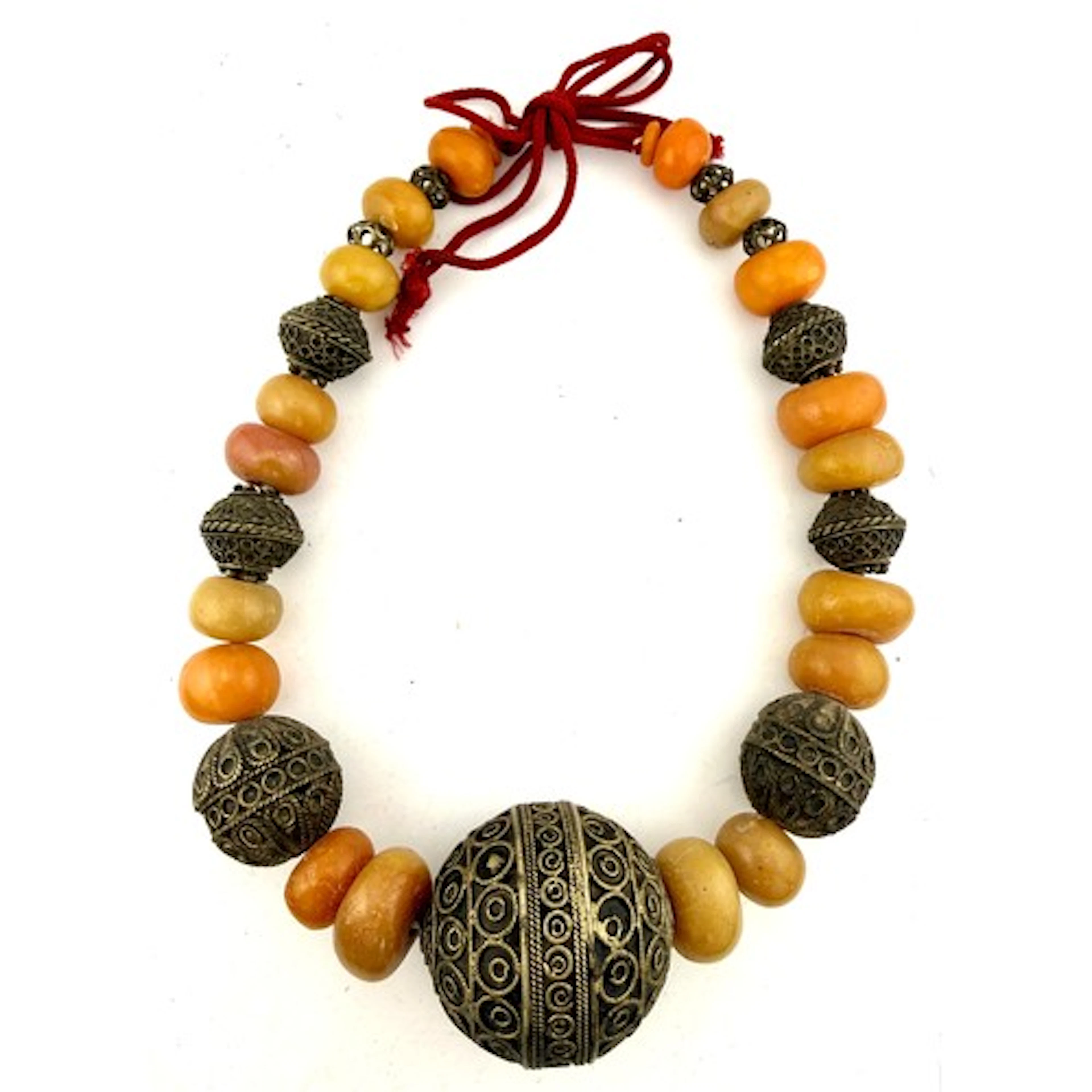 A tribal amber and metal bead necklace. 47cm l.
