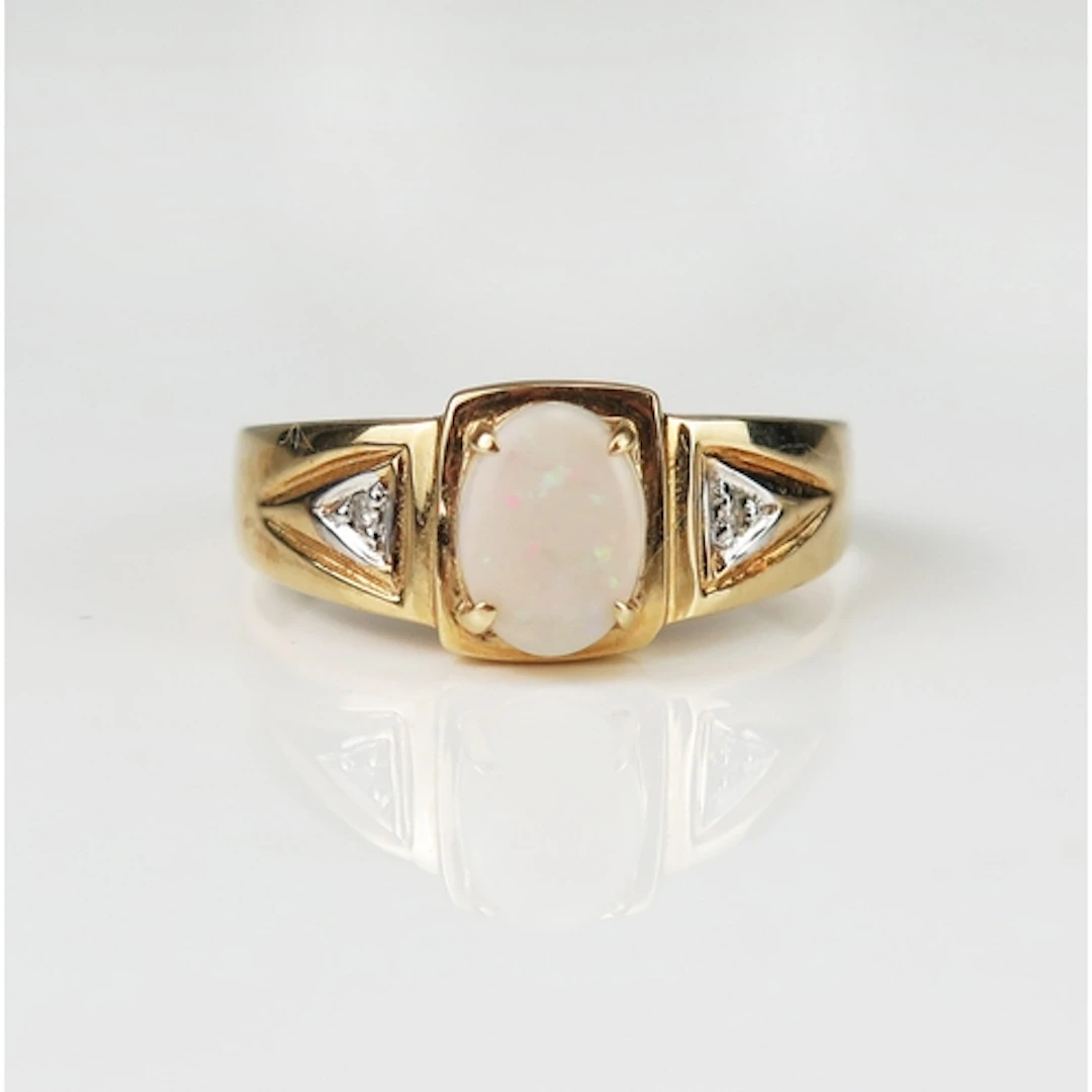 A singlet opal and diamond ring in a 9ct yellow gold setting...