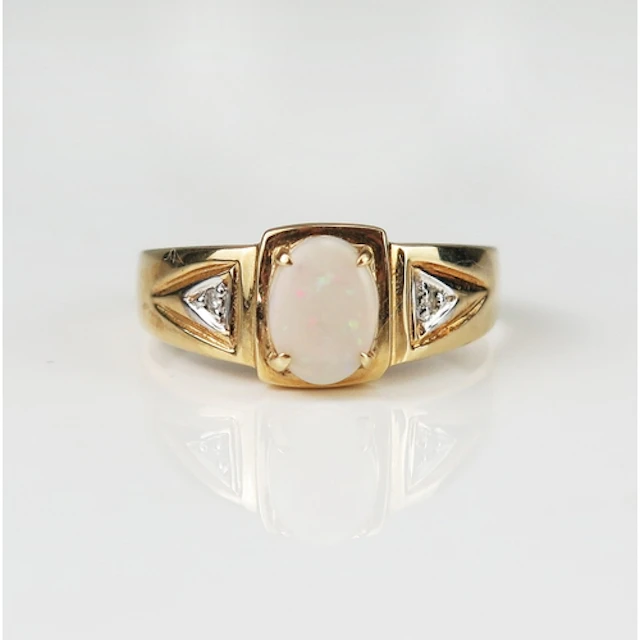 A singlet opal and diamond ring in a 9ct yellow gold setting...