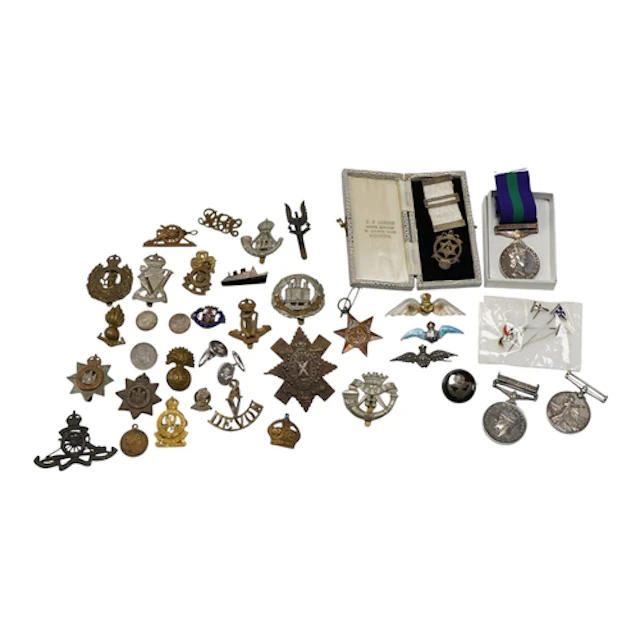 A collection of medals and cap badges, etc., including; a Vi...