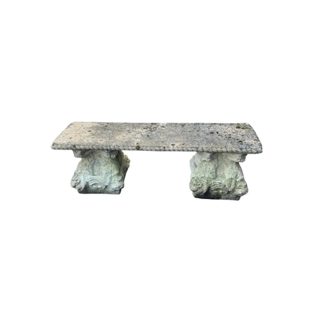 A reconstituted stone garden bench, on acanthus moulded end ...