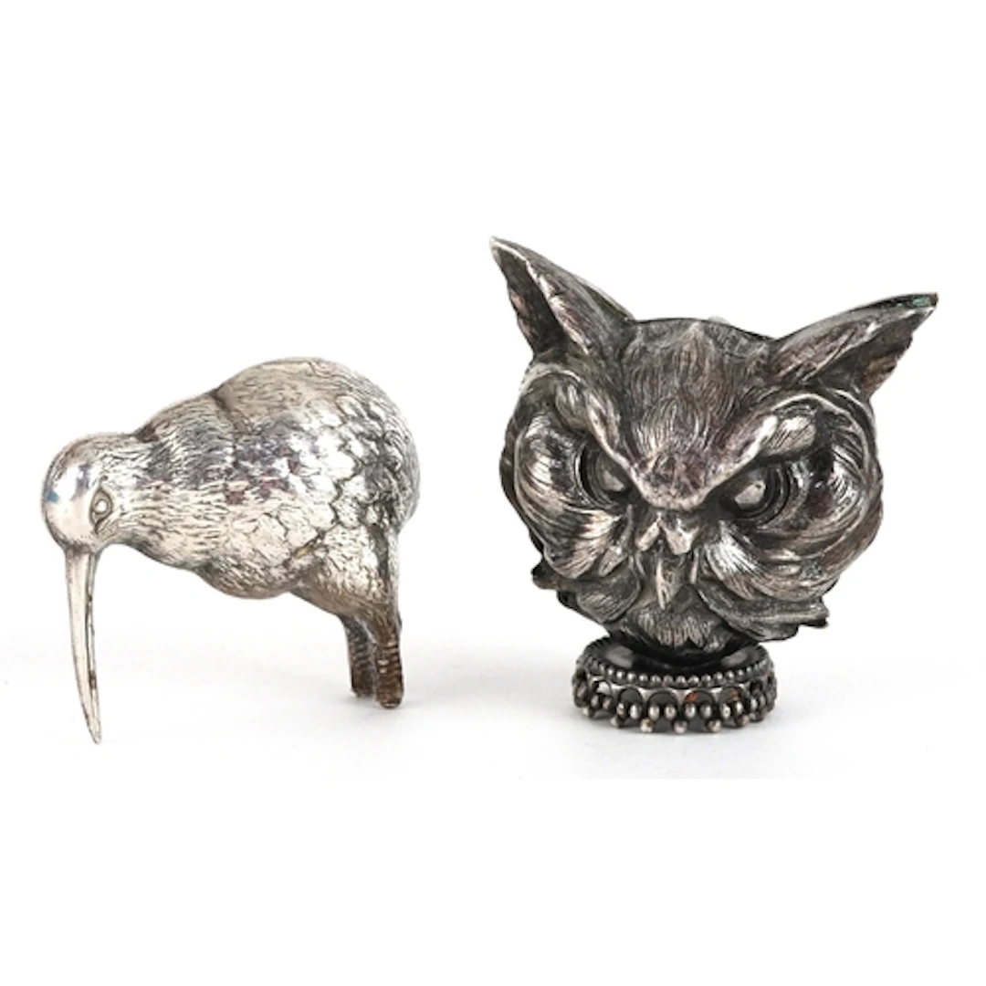Two white metal animals comprising kiwi and owl, the largest...
