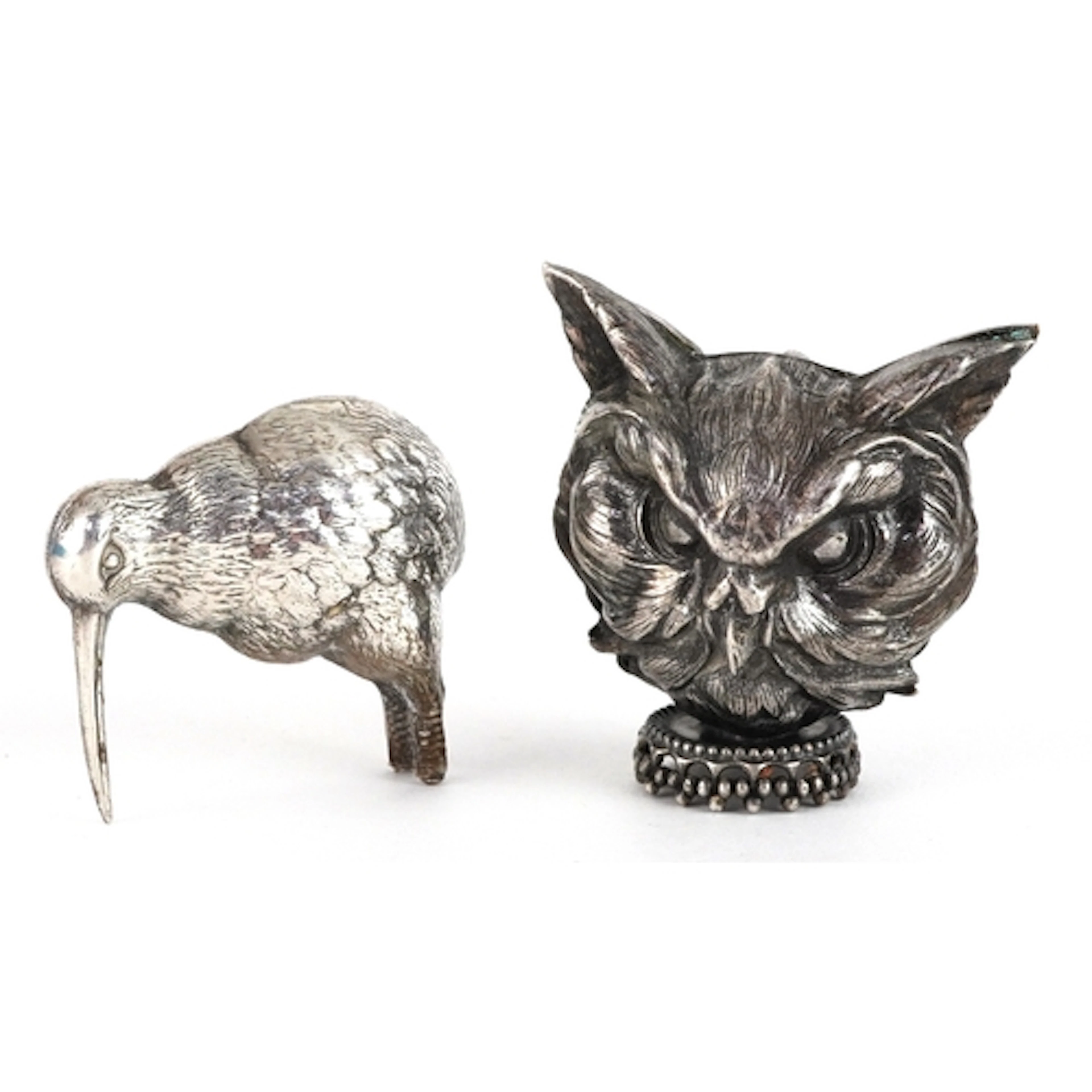Two white metal animals comprising kiwi and owl, the largest...