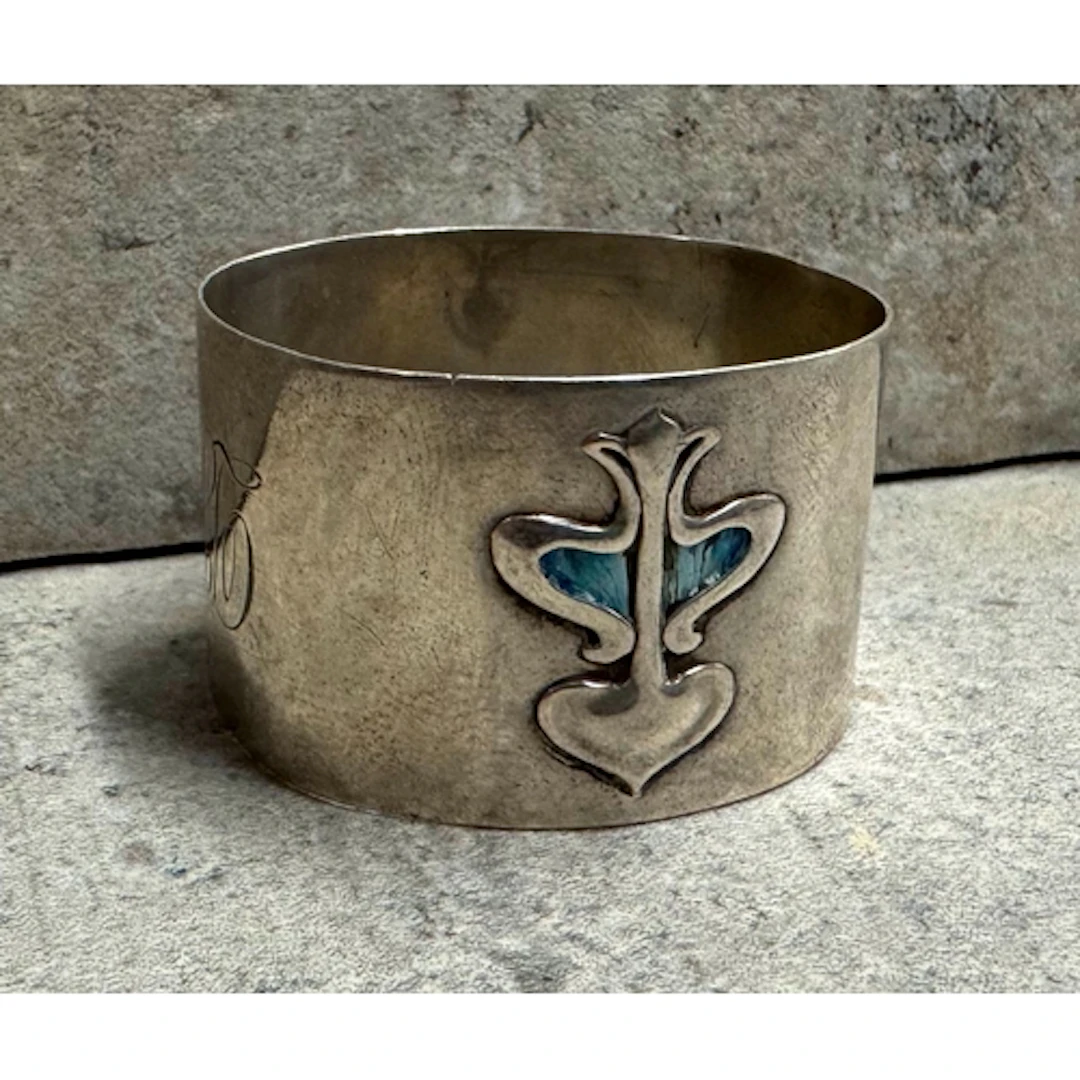 An Art Nouveau silver and enamelled napkin ring. Circa 1910....